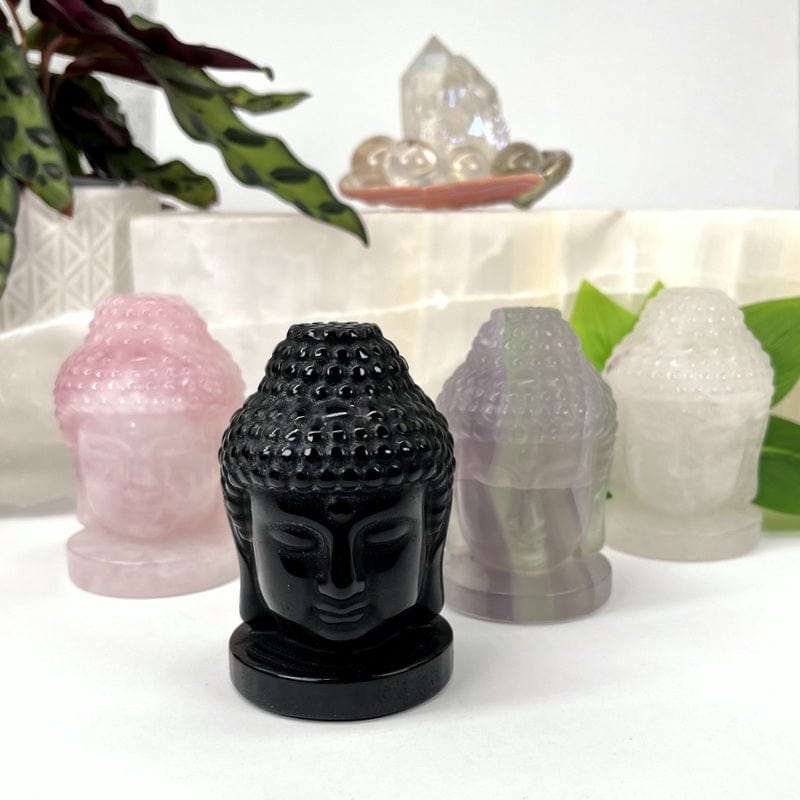 multiple carved buddha heads displayed to show the different stone types 