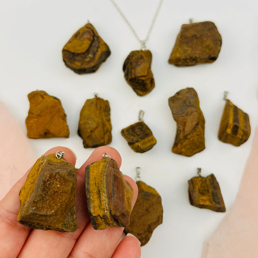 Natural Tiger Eye Crystal Pendants on hand for size reference 