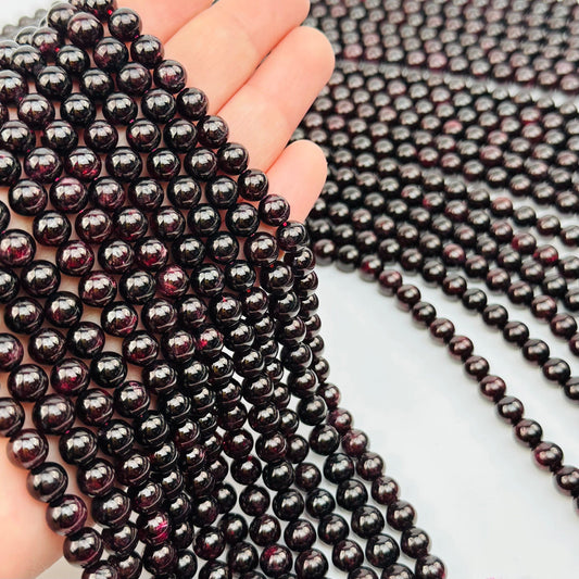multiple Red Garnet Crystal Beads Strand in hand for size reference 
