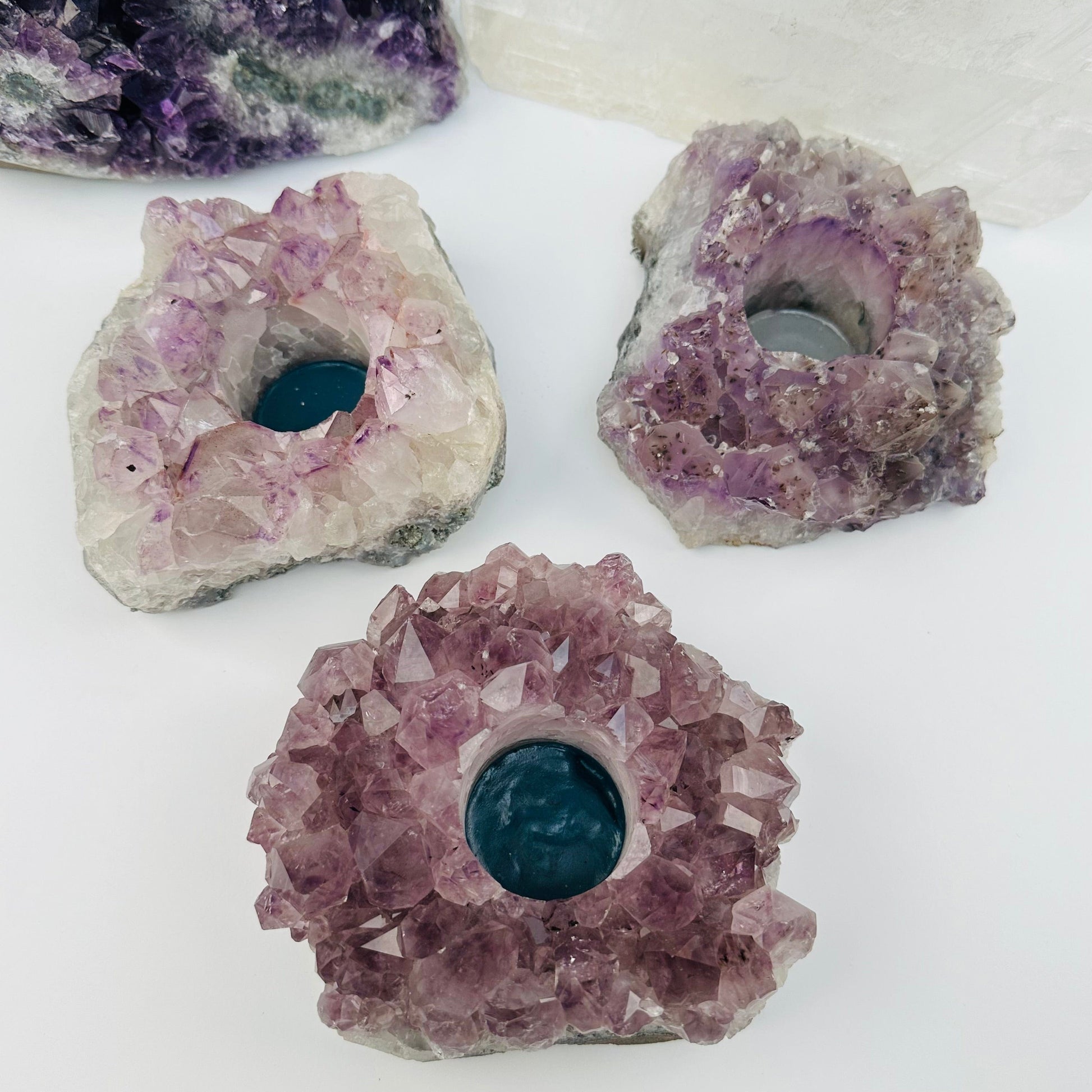 multiple candle holders displayed to show the differences in the sizes and color shades 