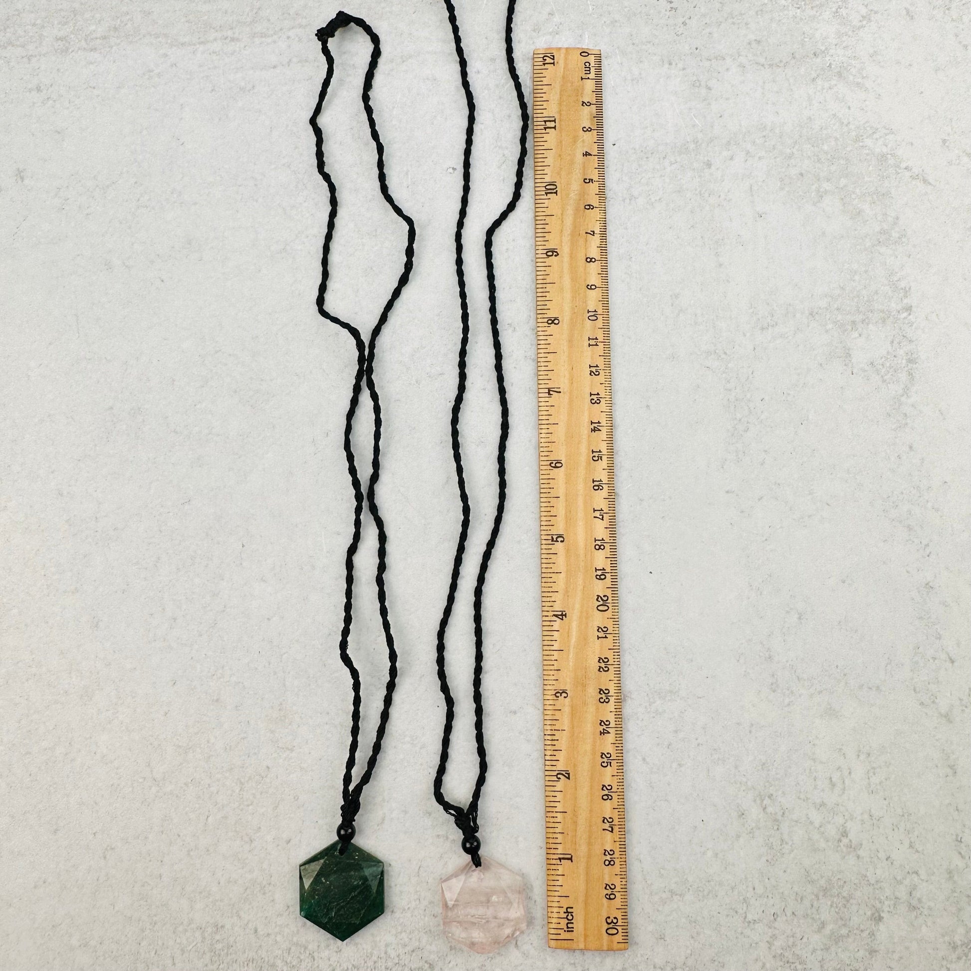 necklaces next to a ruler for size reference 