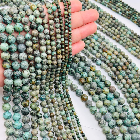Multi-Colored Polished Amazonite Crystal Beads on hand for size reference 