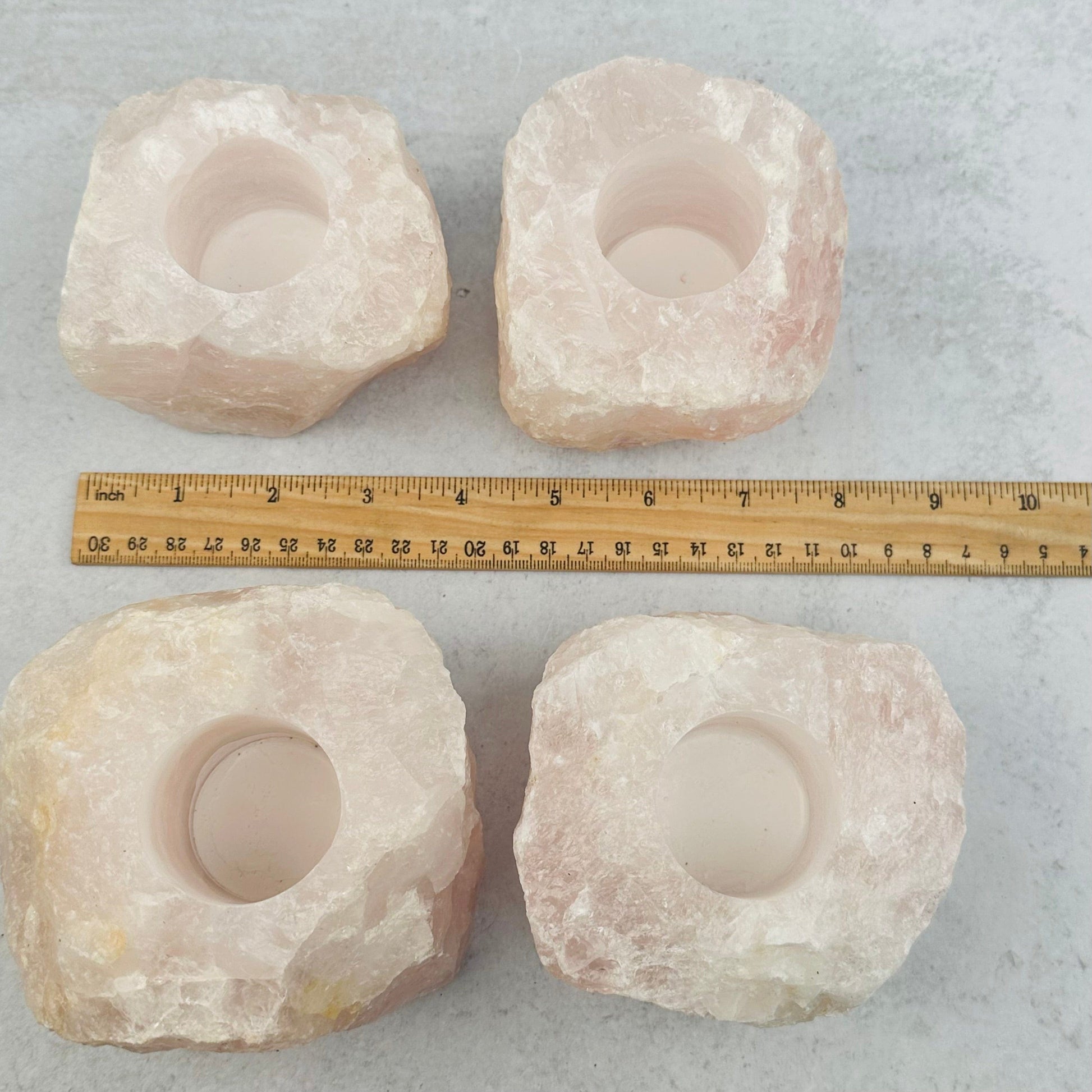 candle holders next to a ruler for size reference 