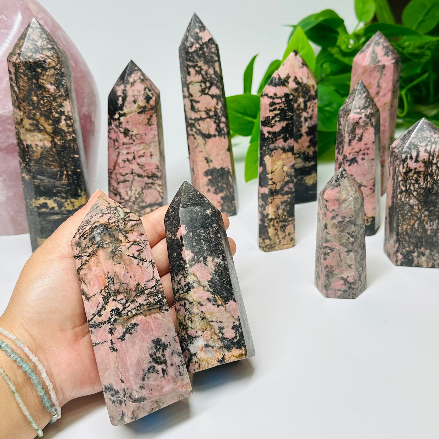 Rhodonite Crystal Polished Points in hand for size reference 