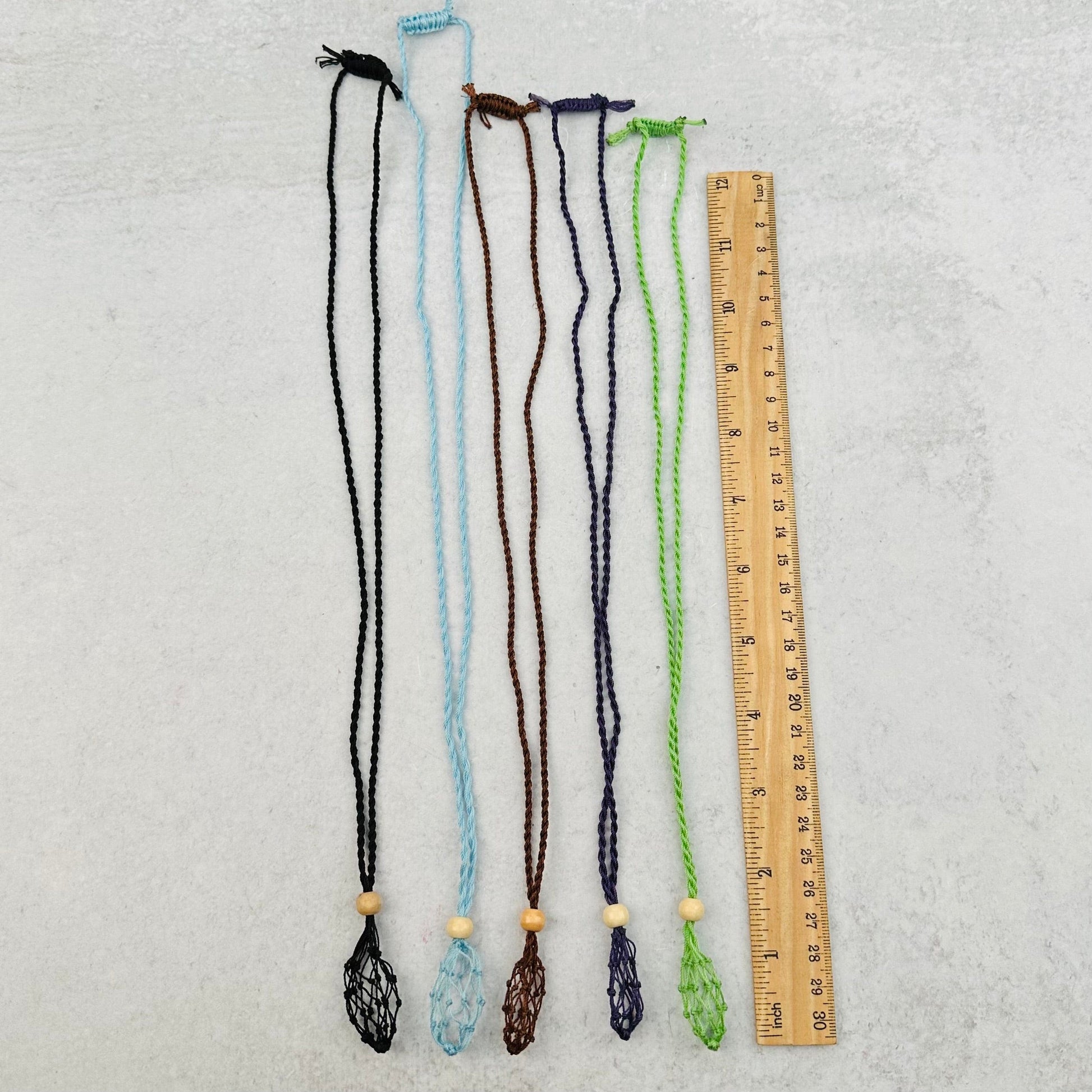 necklaces next to a ruler for size reference 
