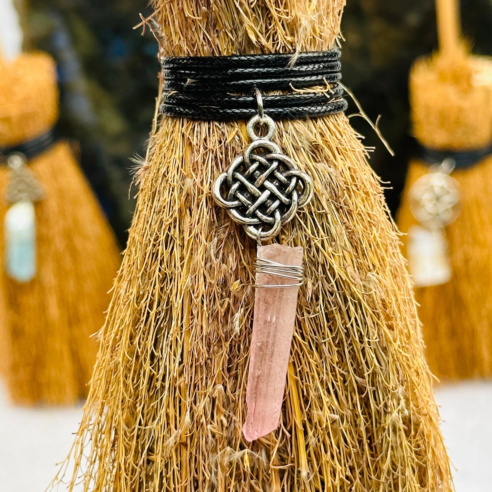 close up of the charm and crystal on this protection broom 