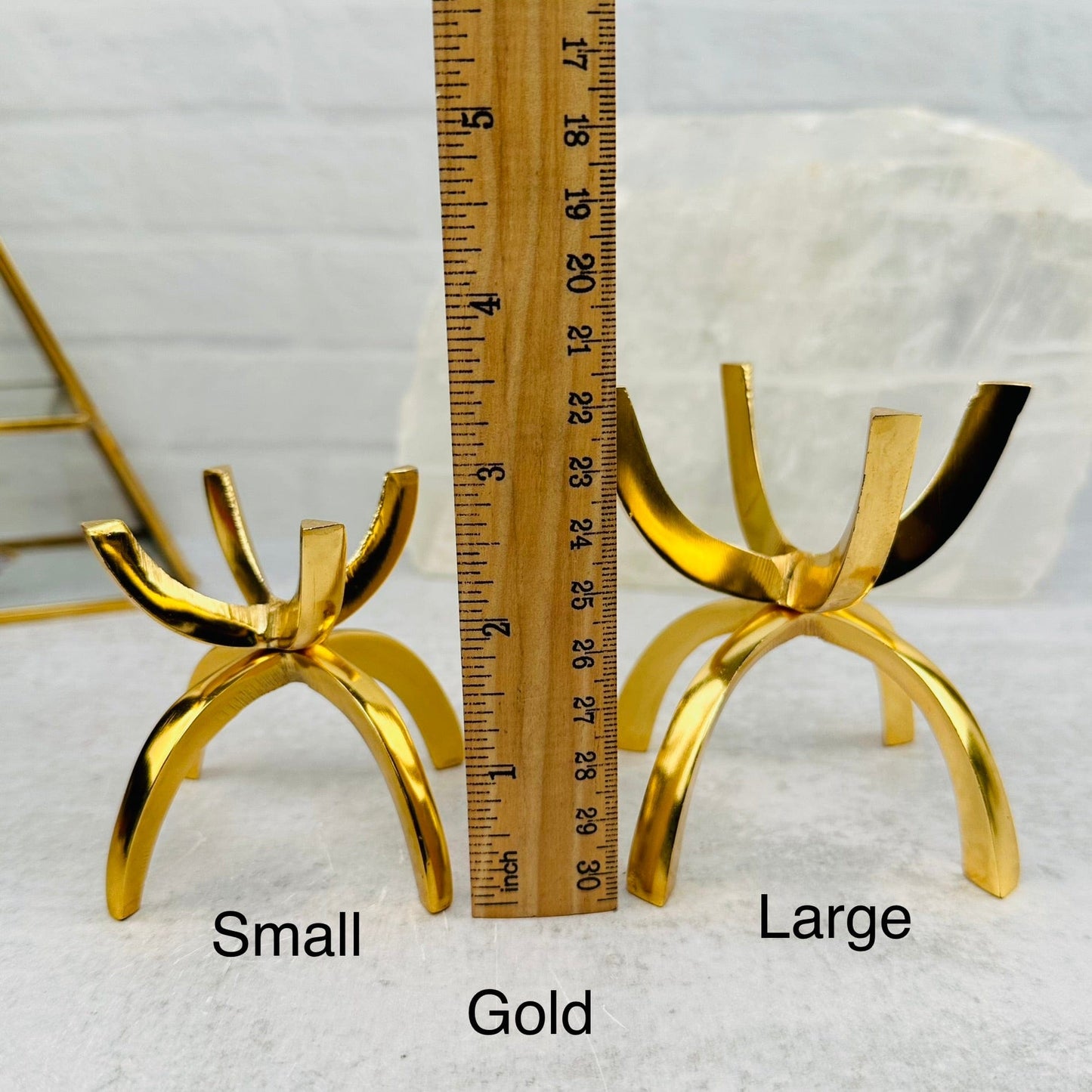 aluminum sphere holder next to a ruler for size reference