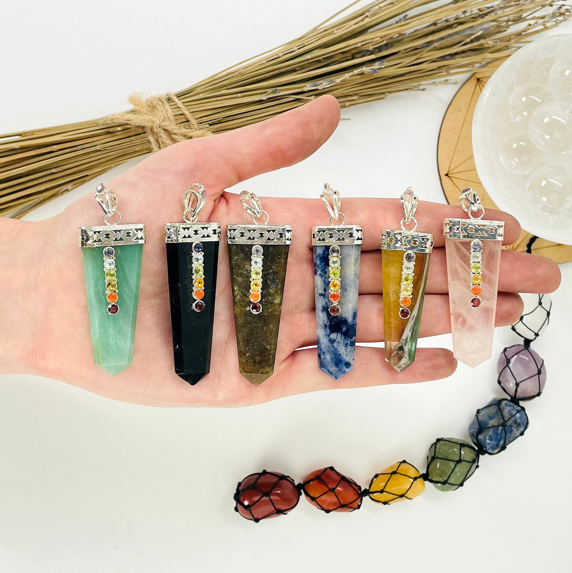 one of each polished point pendant options in hand