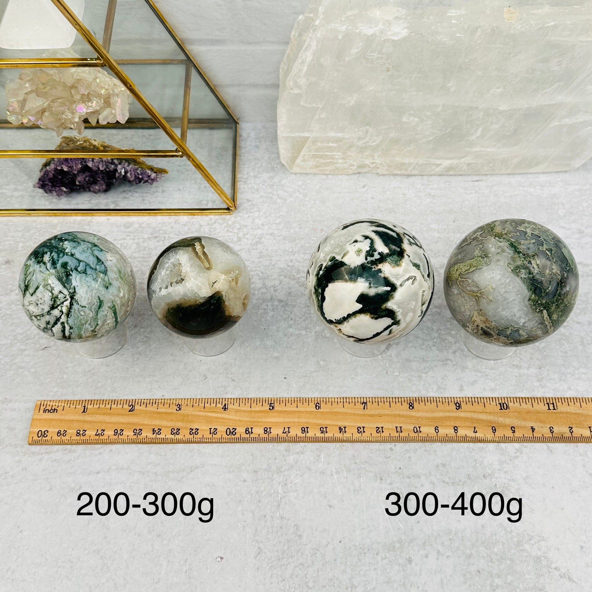 Moss Agate Spheres - By Weight - next to a ruler for size reference 