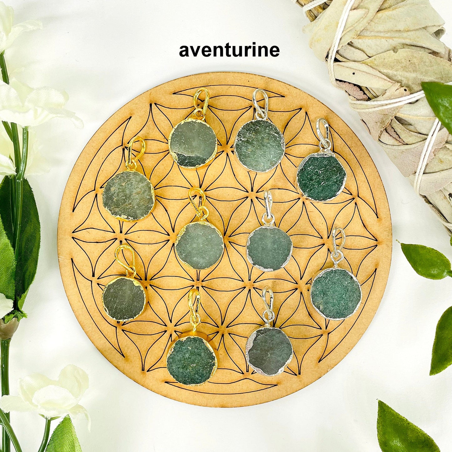 overhead view of five gold and five silver round aventurine pendants on display with decorations for possible variations and finish comparison