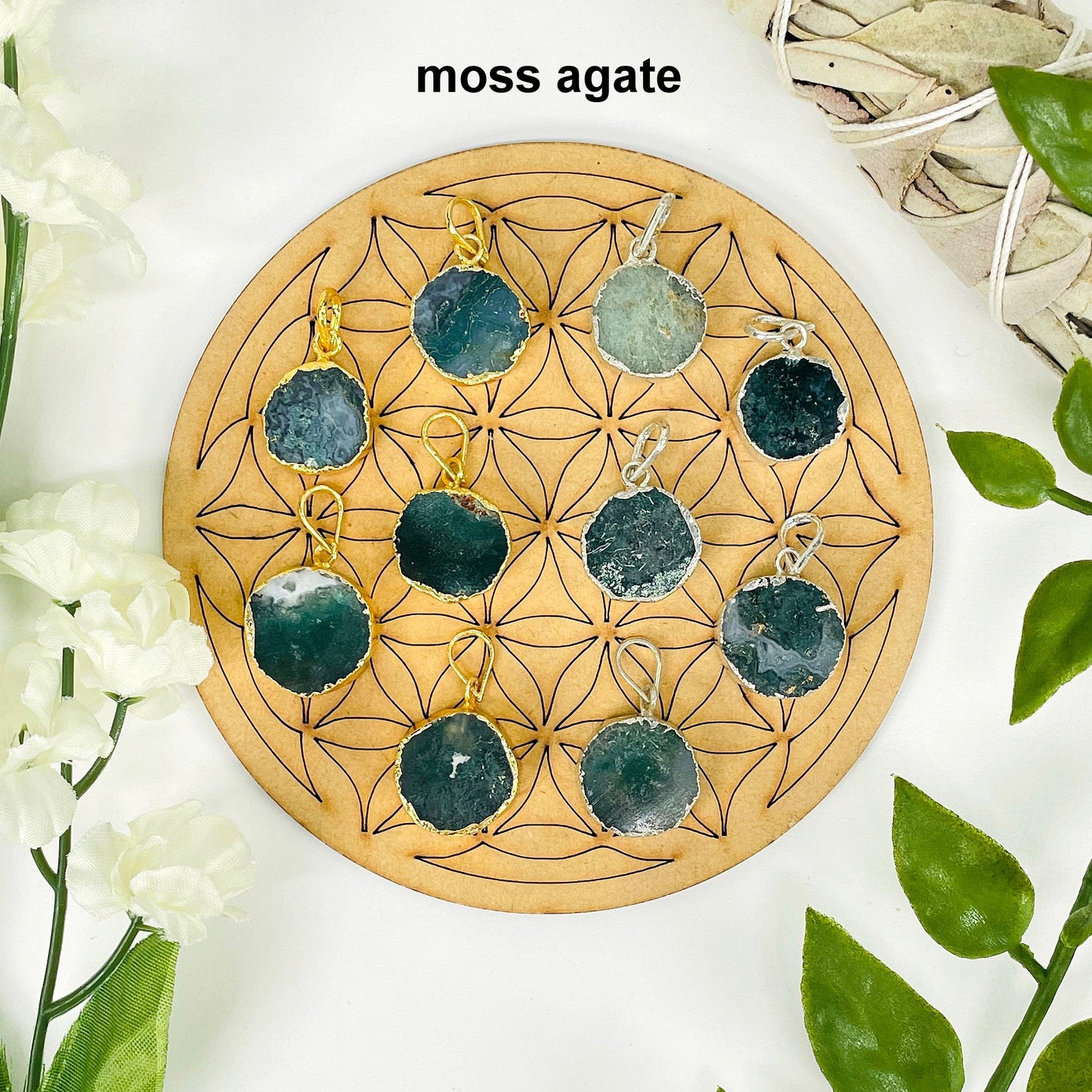 overhead view of five gold and five silver round moss agate pendants on display with decorations for possible variations and finish comparison