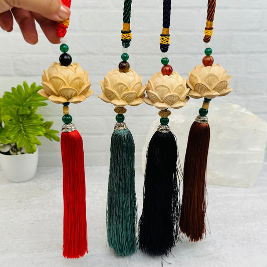 wooden lotus flower tassel with decorations in the background