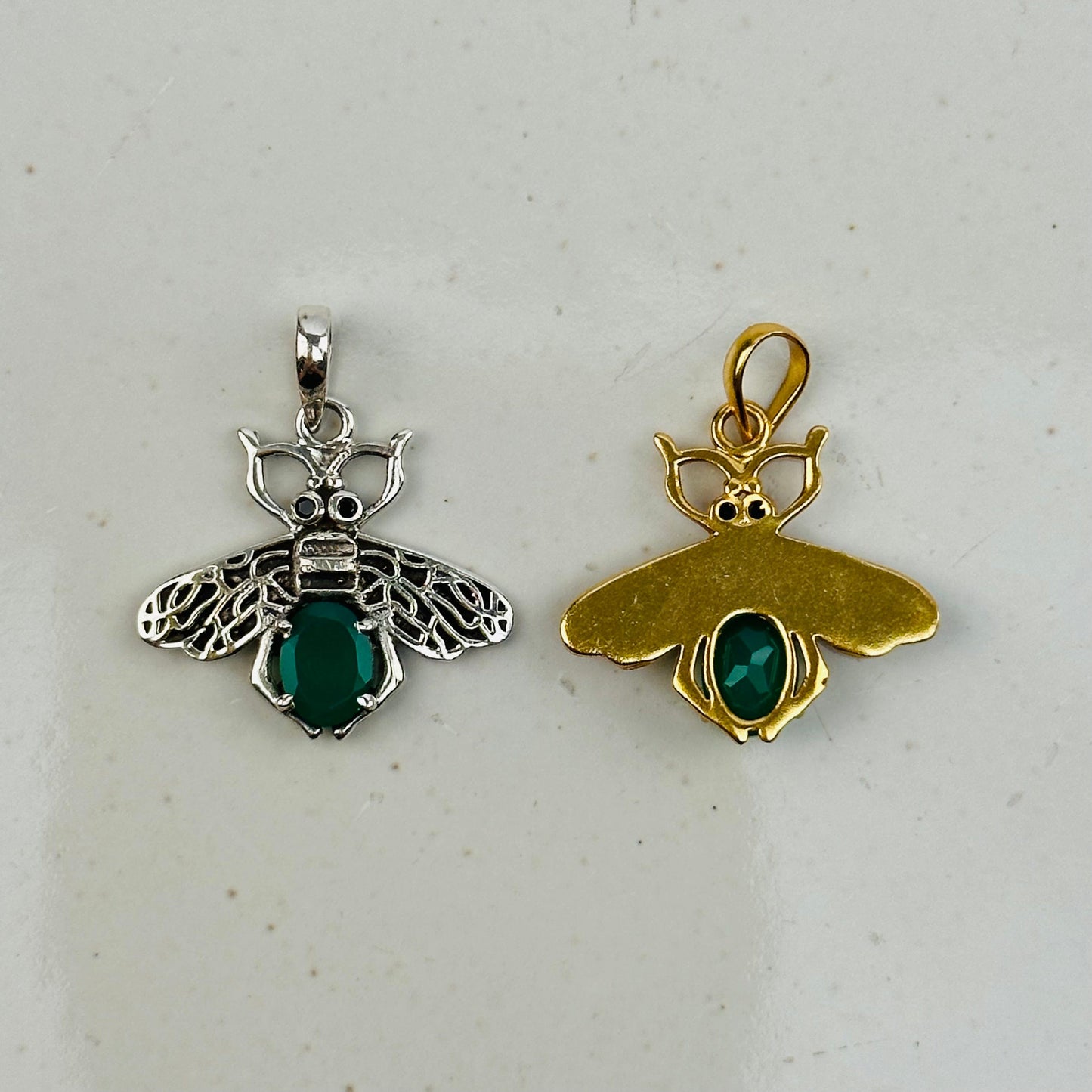 crystal bee pendants on gray background