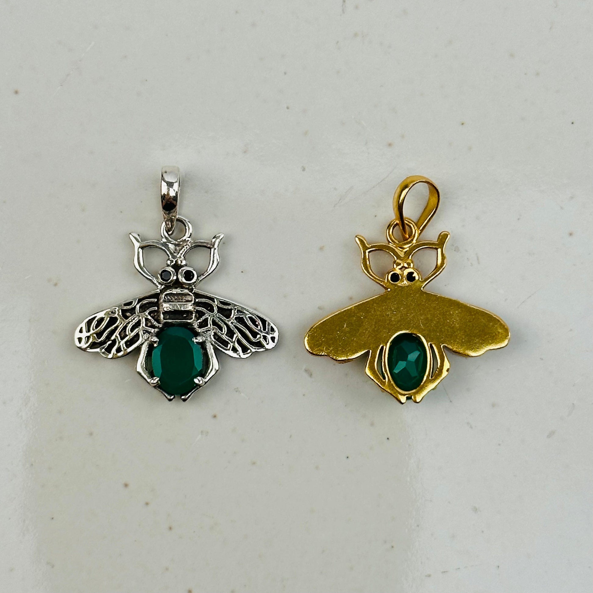 crystal bee pendants on gray background