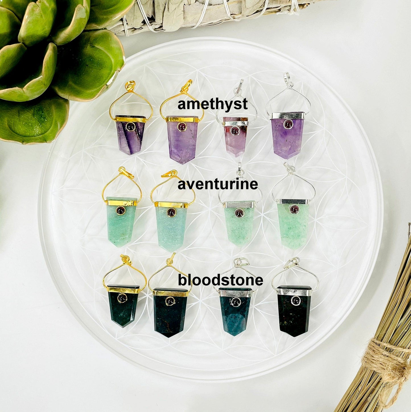 overhead view of two gold and two silver amethyst, aventurine, and bloodstone shield pendants