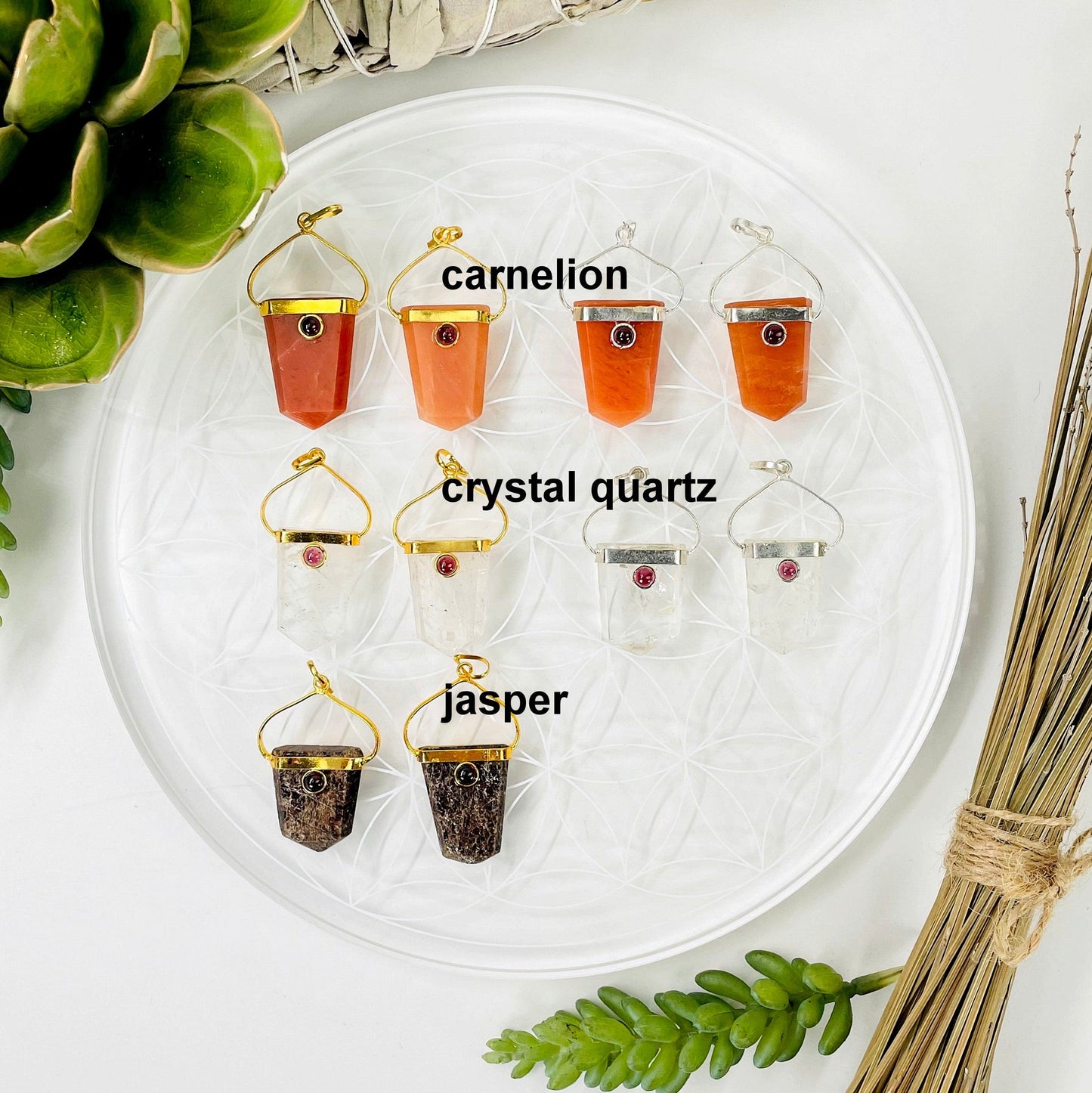 overhead view of two gold and two silver carnelian and crystal quartz shield pendants and two gold jasper shield pendants