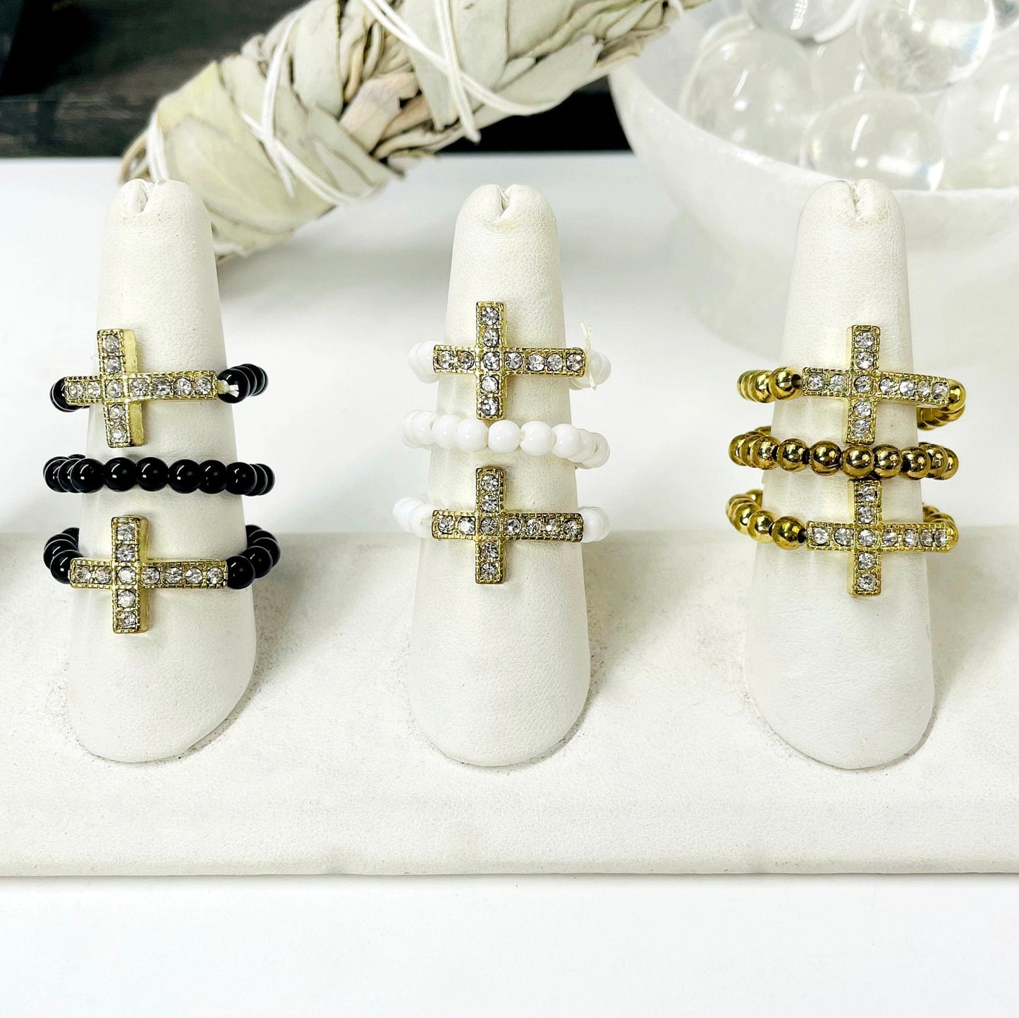 three of each sideways cross elastic ring color options on ring display