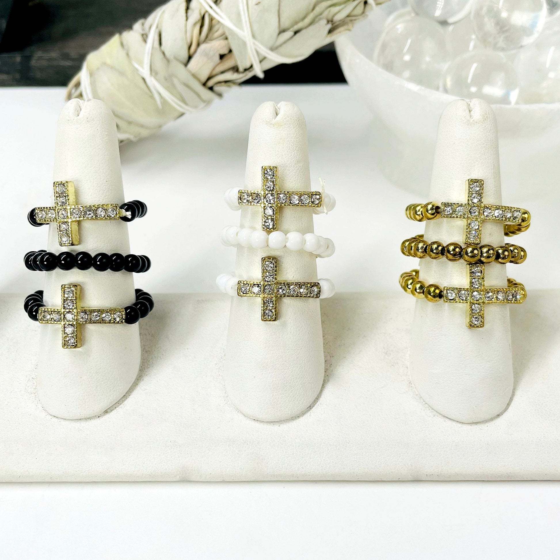 three of each sideways cross elastic ring color options on ring display