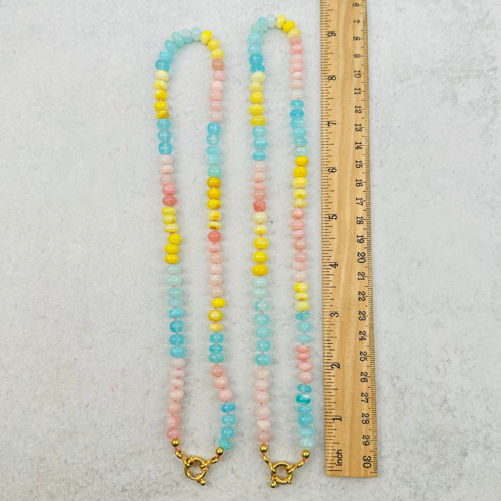 necklaces next to a ruler for size reference 