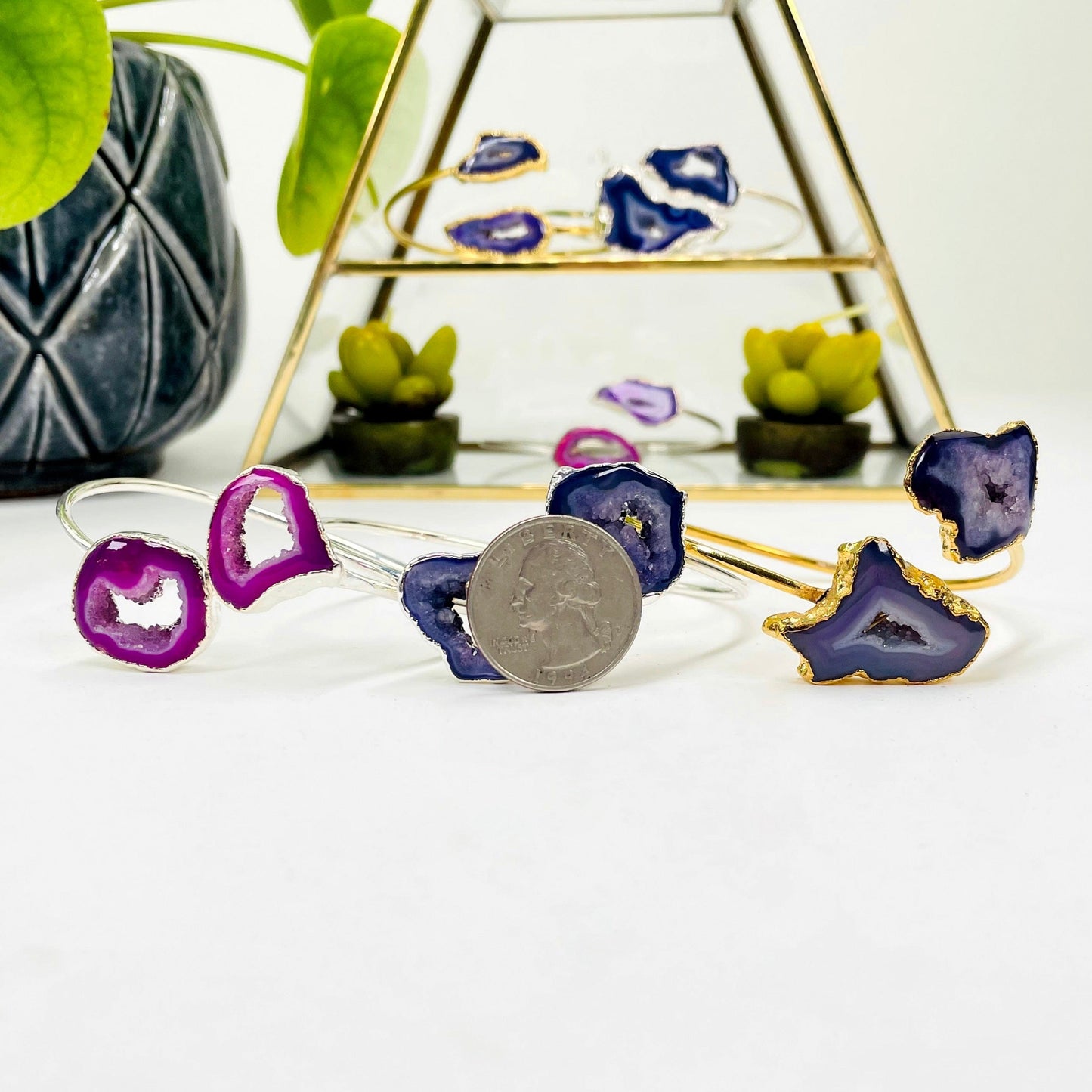 one of each double agate adjustable bracelet options in a row with a quarter for agate size reference