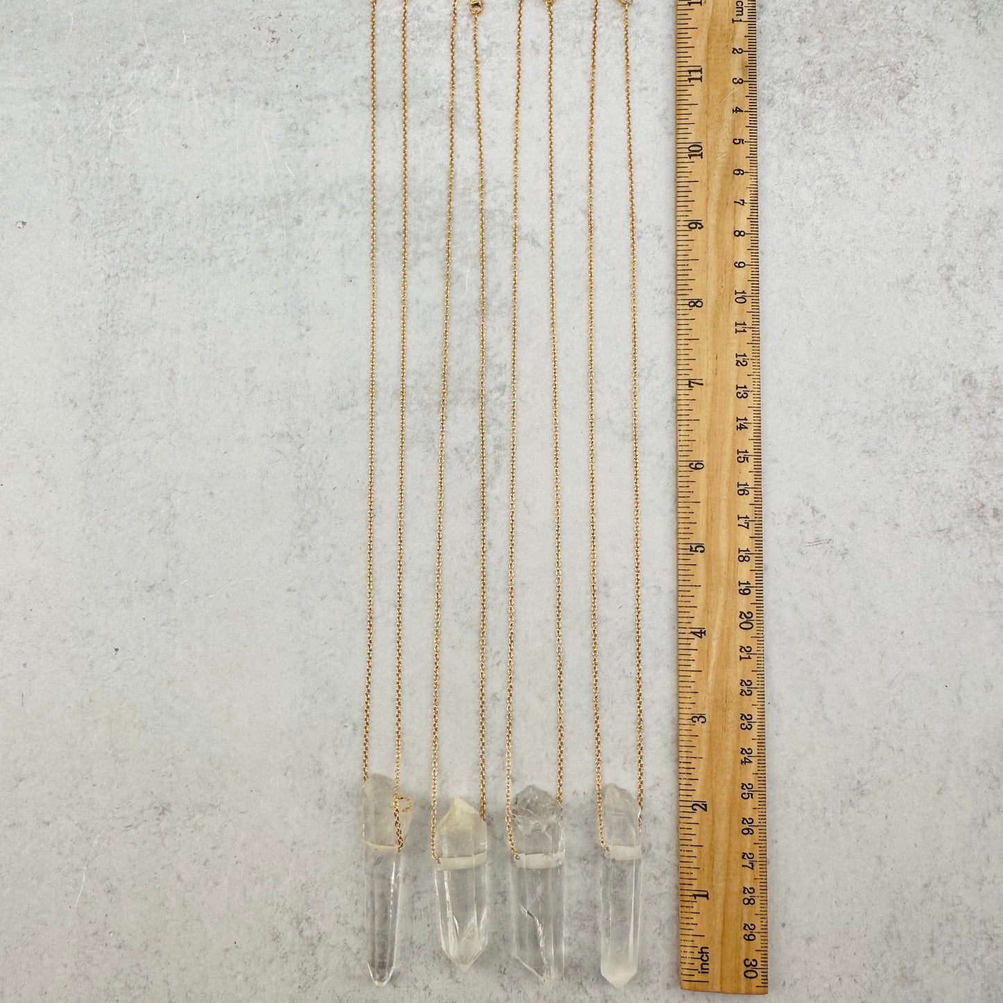necklaces next to a ruler for size reference 
