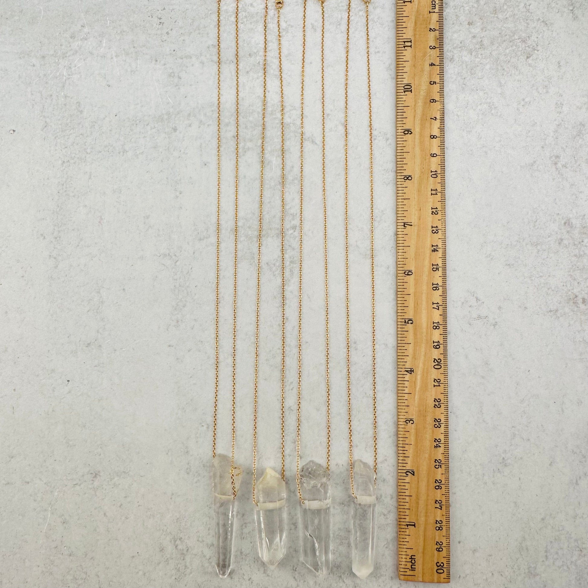 necklaces next to a ruler for size reference 