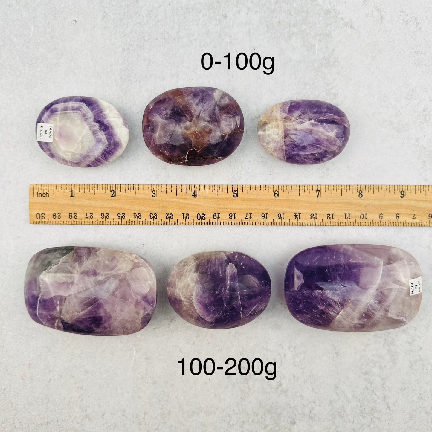 palm stones next to a ruler for size reference 
