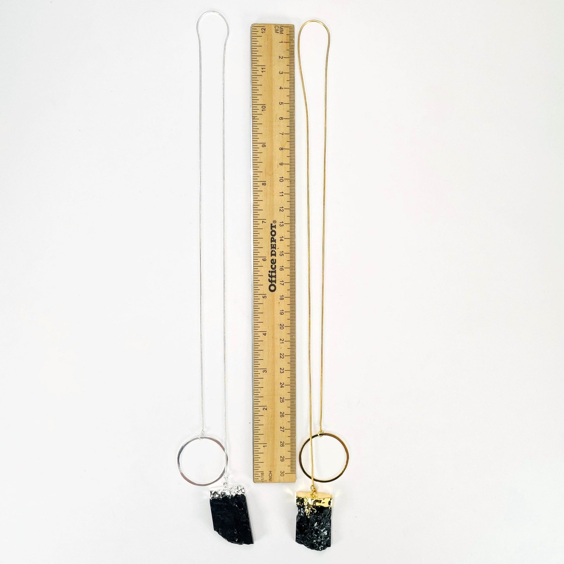 full length of one gold and one silver obsidian chunk adjustable necklace with a ruler for length reference