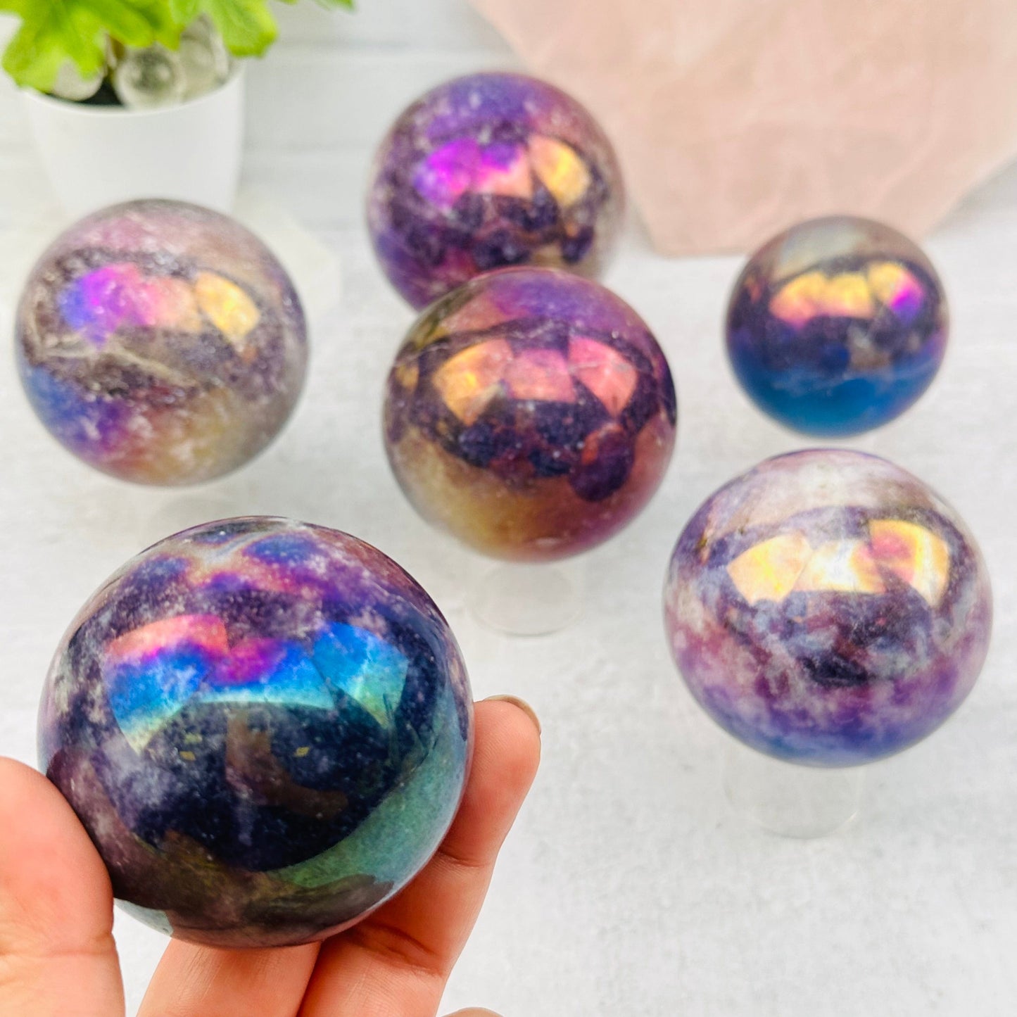 Angel Aura Lepidolite Sphere in hand for size reference 