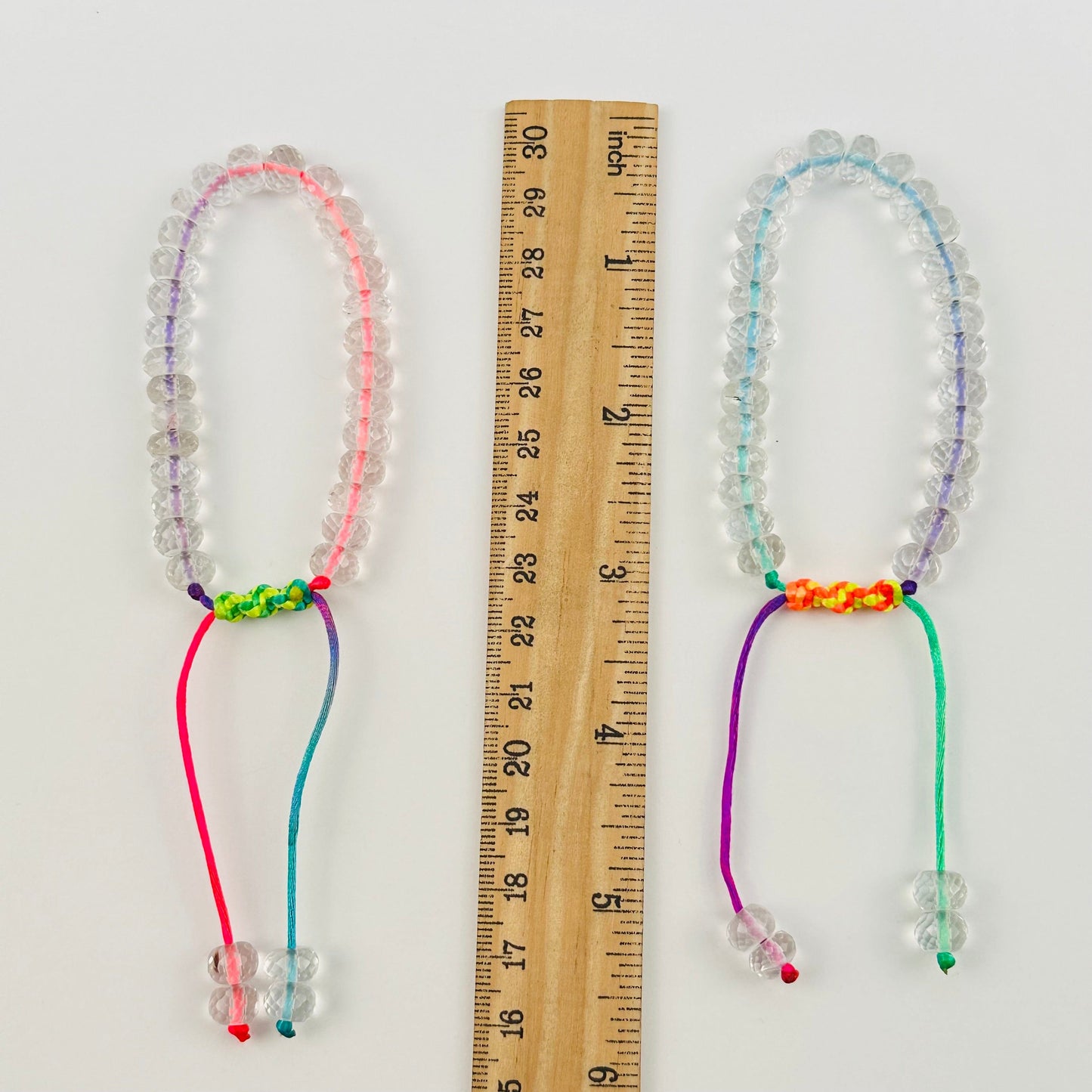 bracelets next to a ruler for size reference 