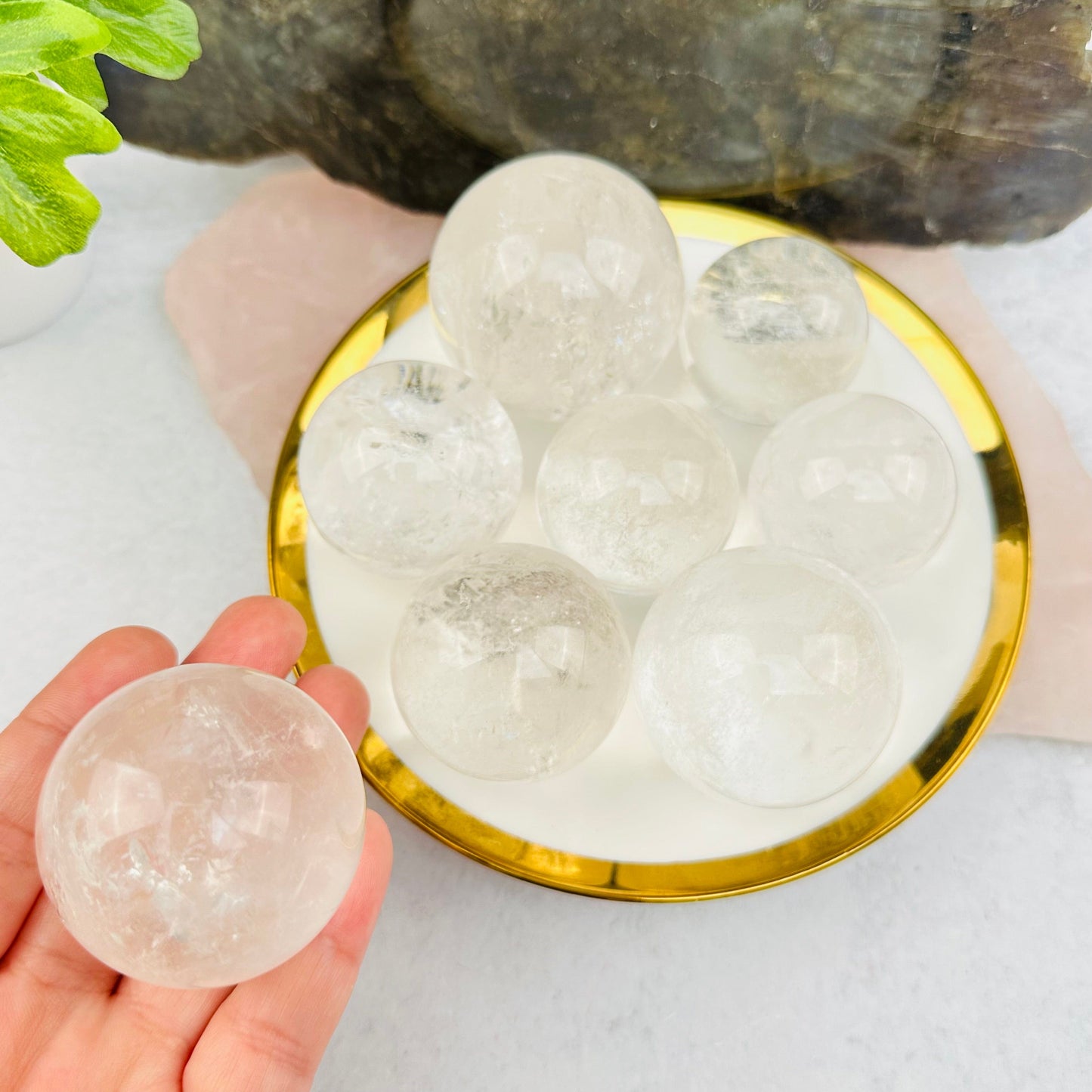 Crystal Quartz Polished Sphere in hand for size reference 