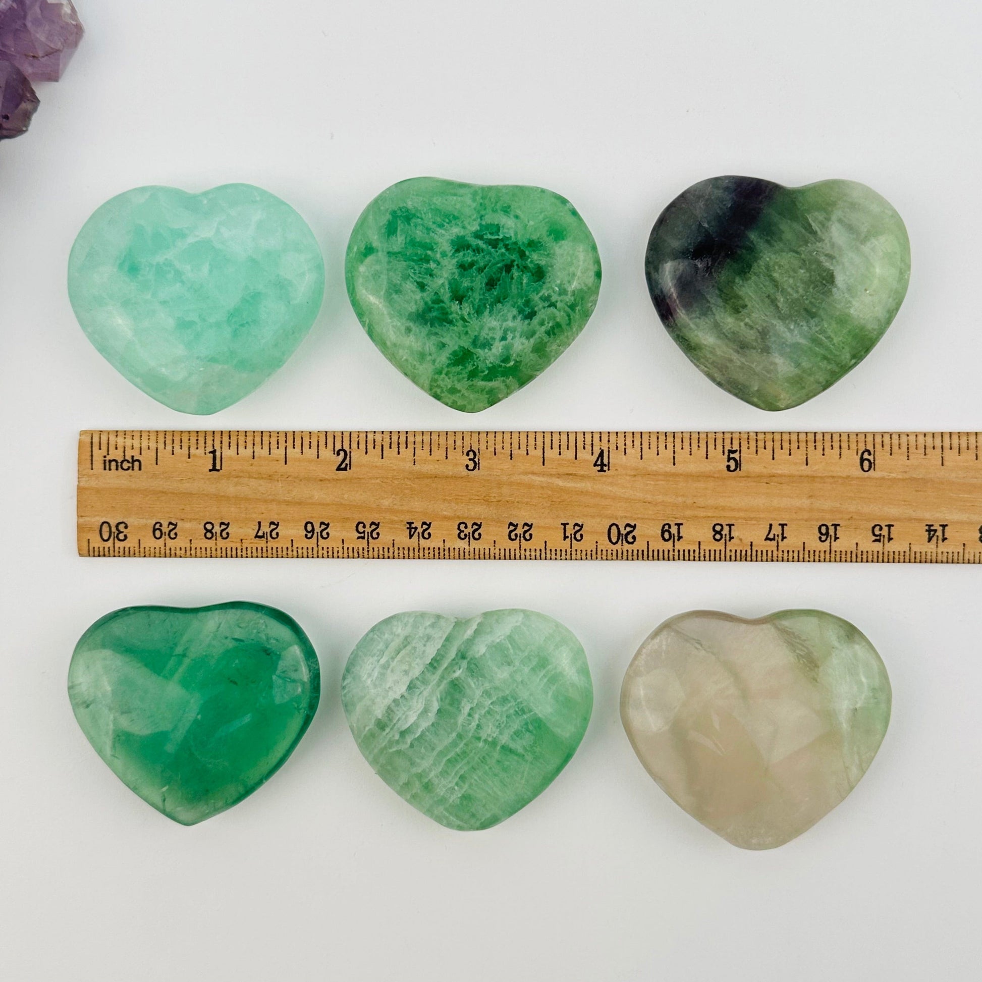 crystals next to a ruler for size reference 