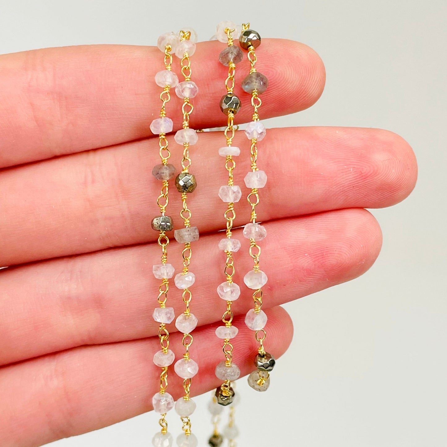 close up of  beaded chain in hand for details
