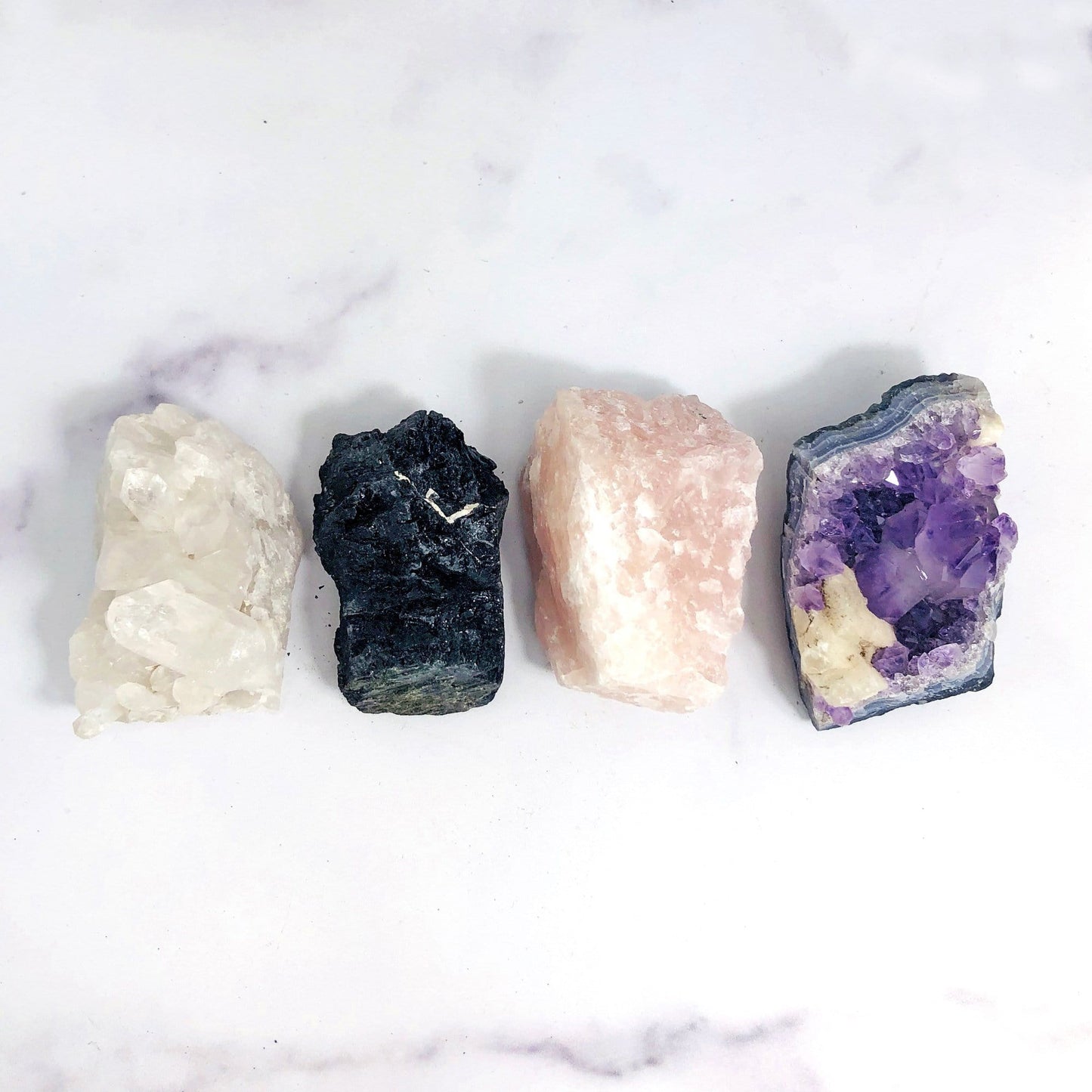 crystal quartz cluster black tourmaline rose quartz and amethyst cluster laid out