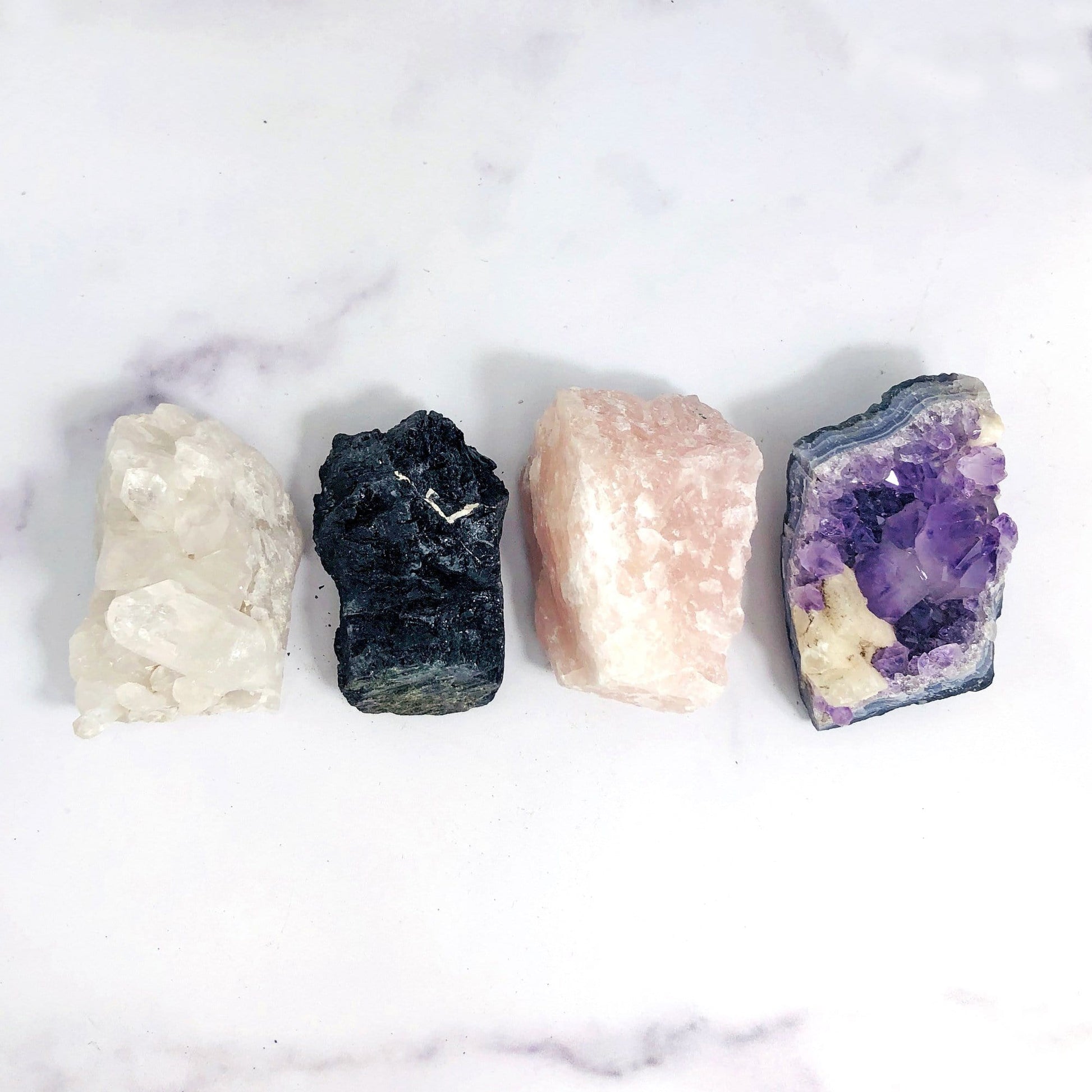 crystal quartz cluster black tourmaline rose quartz and amethyst cluster laid out