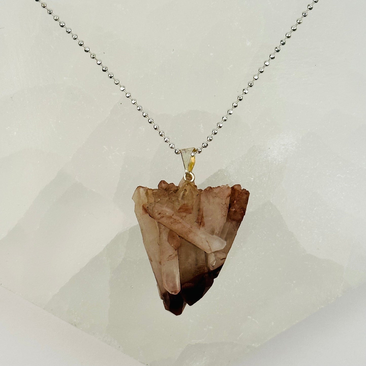lithium quartz pendants with decorations in the background