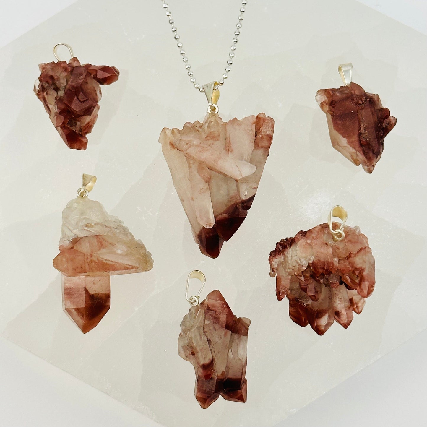 lithium quartz pendants with decorations in the background
