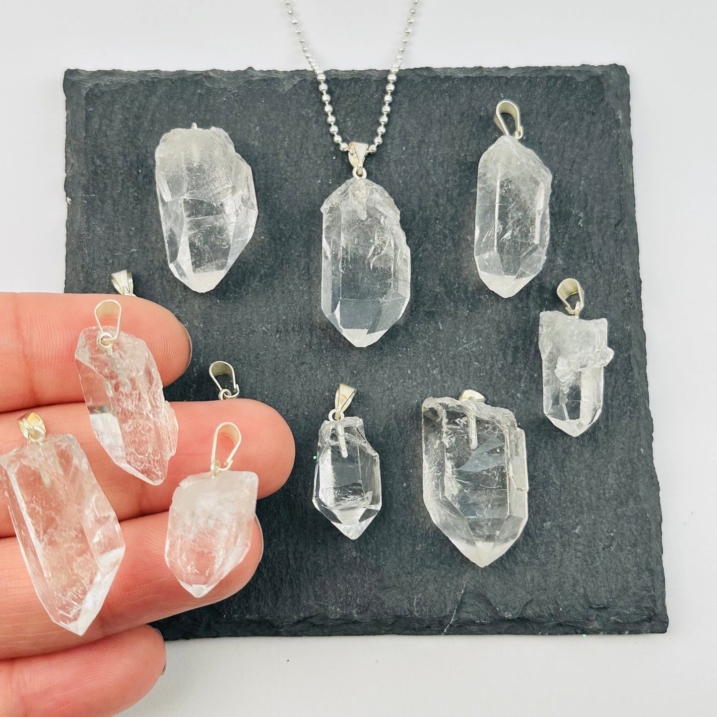 Crystal Quartz Rough Point Pendant Charm - Silver Bail in hand for size reference 