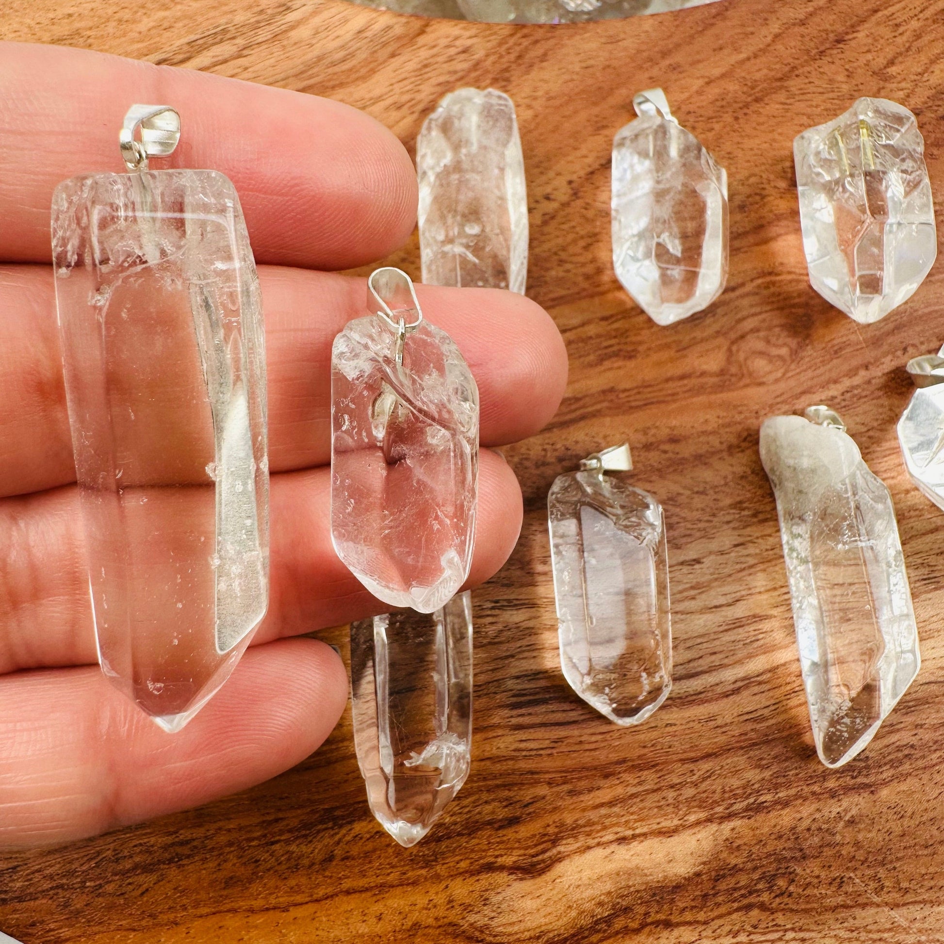 Crystal Quartz Polished Point Pendant Charm - Silver Bail in hand for size reference 
