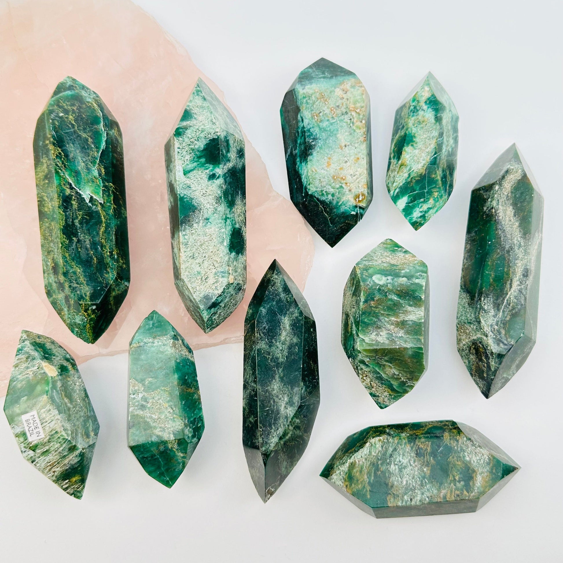 multiple fuchsite double terminated crystals displayed to show the differences in the sizes and color shades 