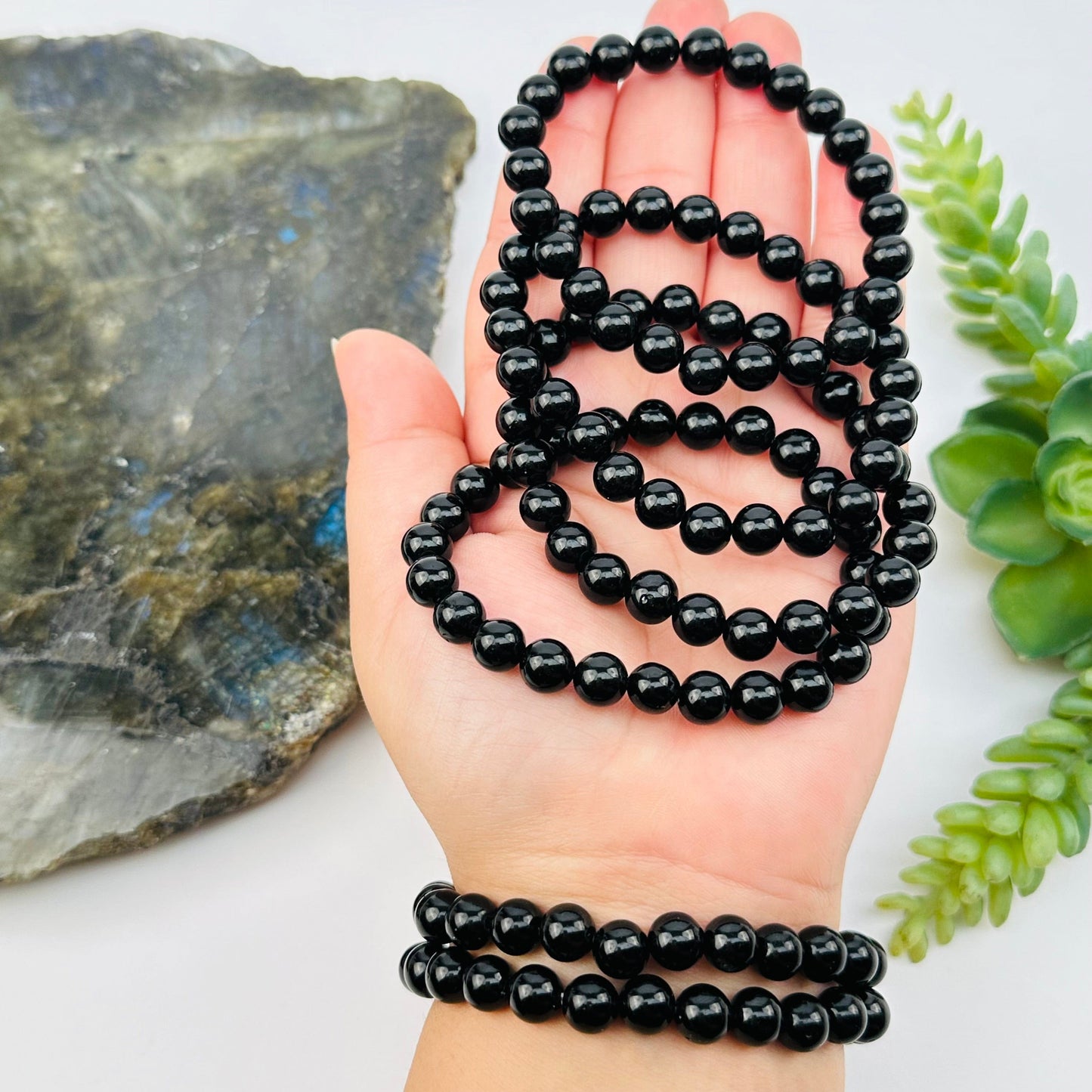 black tourmaline crystal bracelet in hand for size reference 