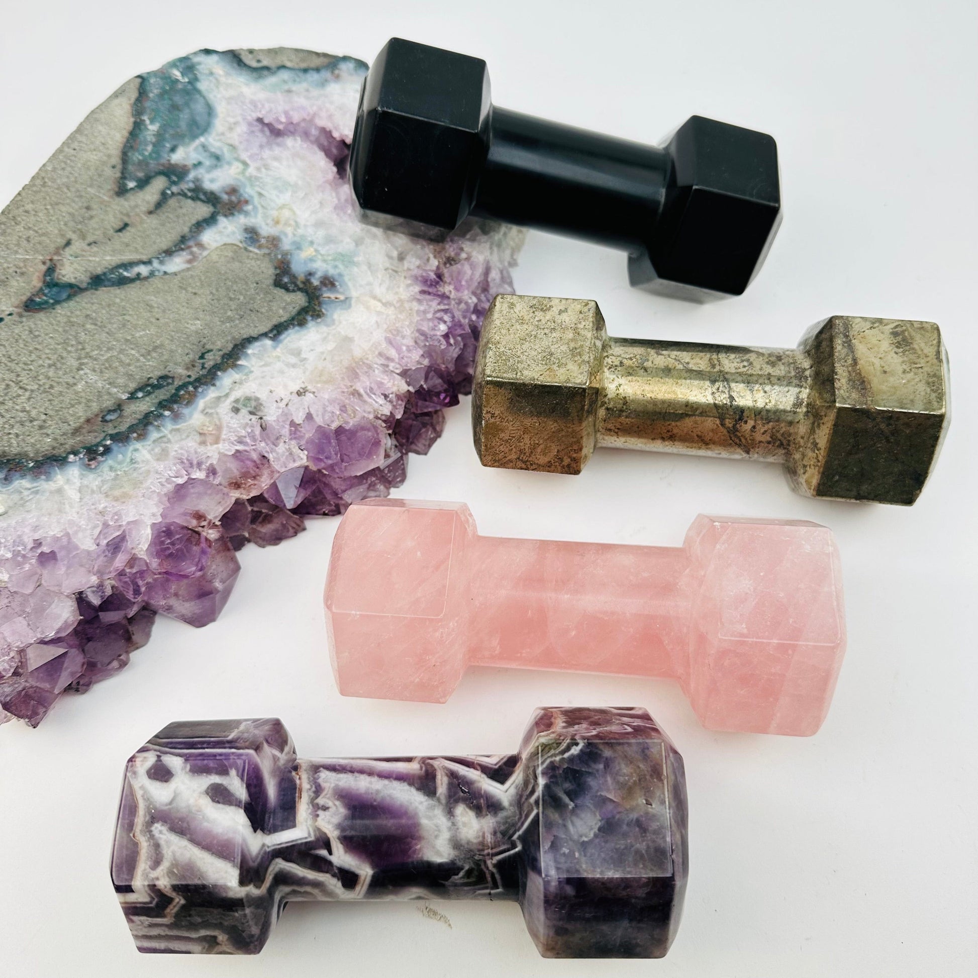 multiple crystal dumbbells displayed to show the differences in the crystal types