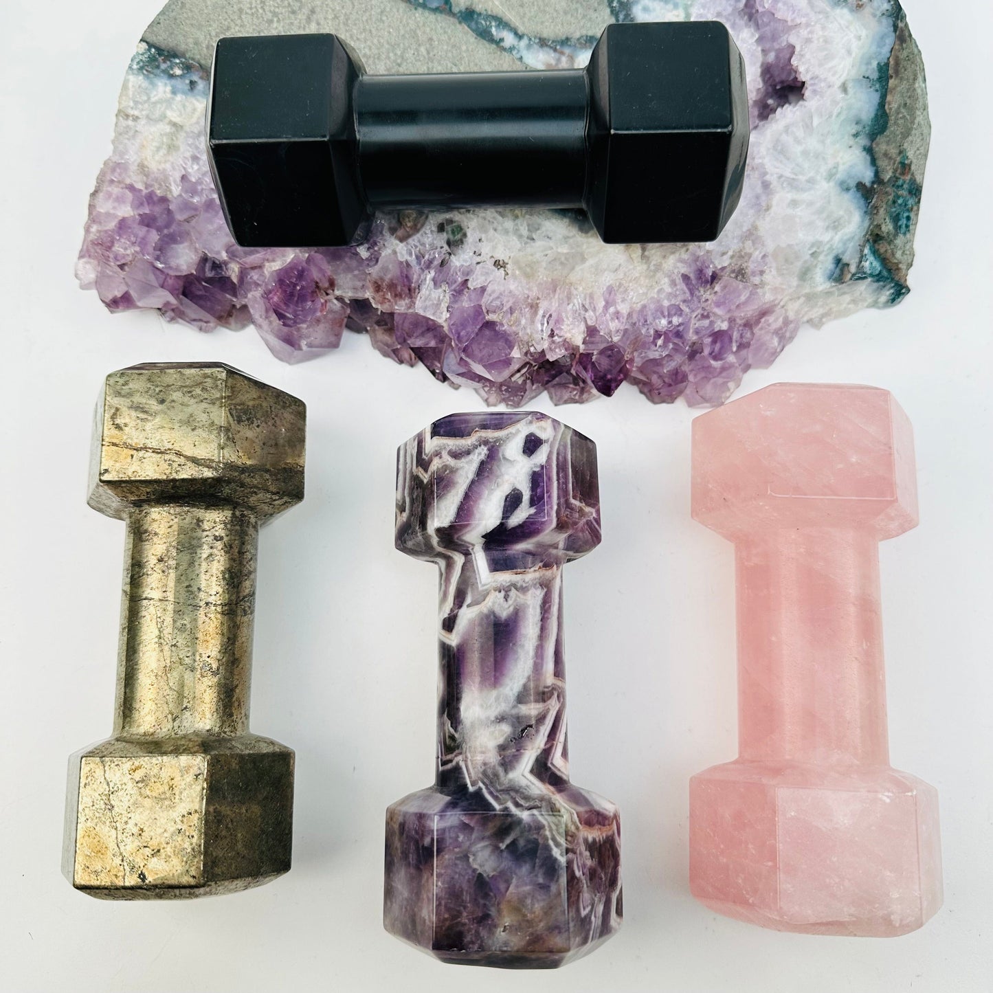 multiple crystal dumbbells displayed to show the differences in the crystal types