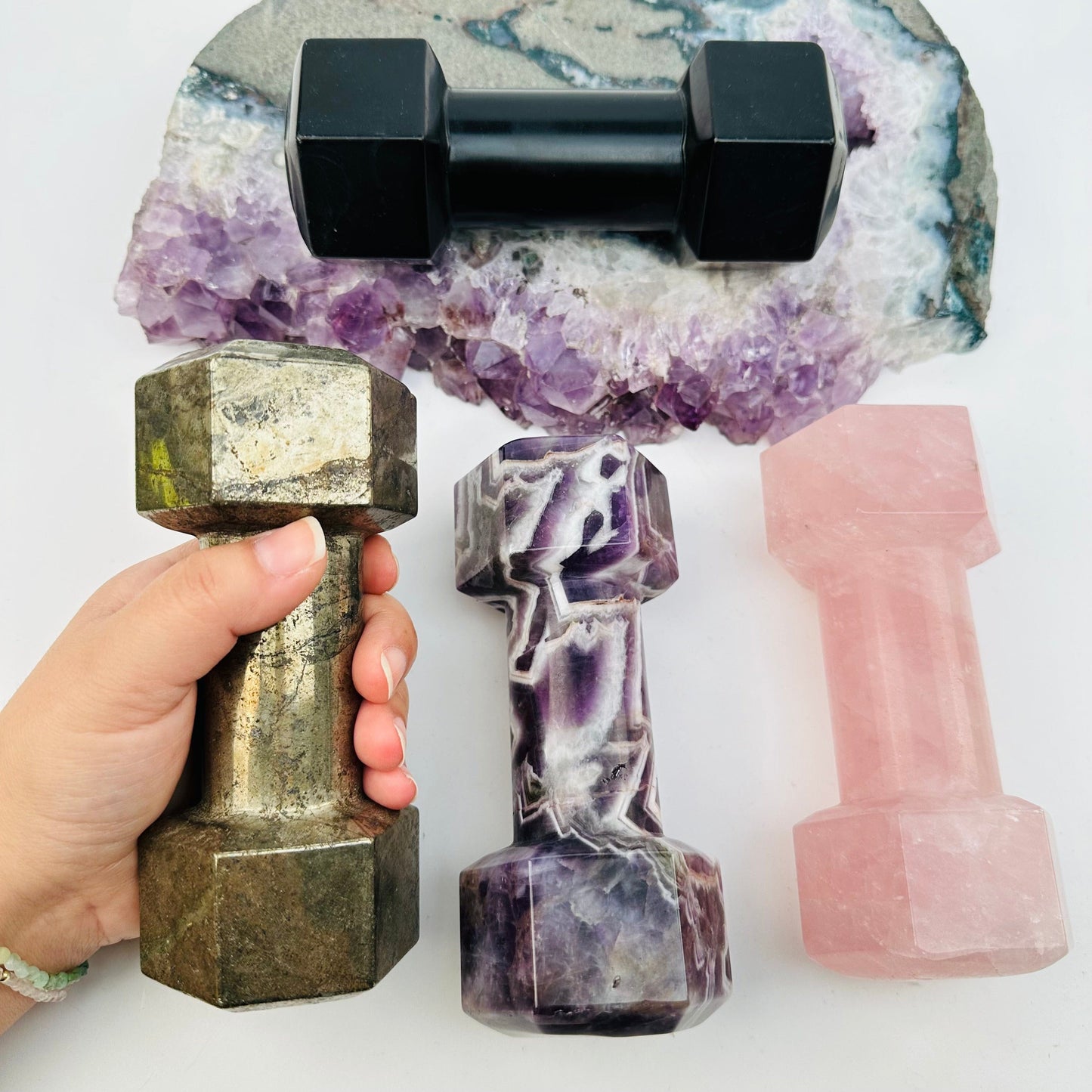 multiple crystal dumbbells displayed to show the differences in the crystal types
