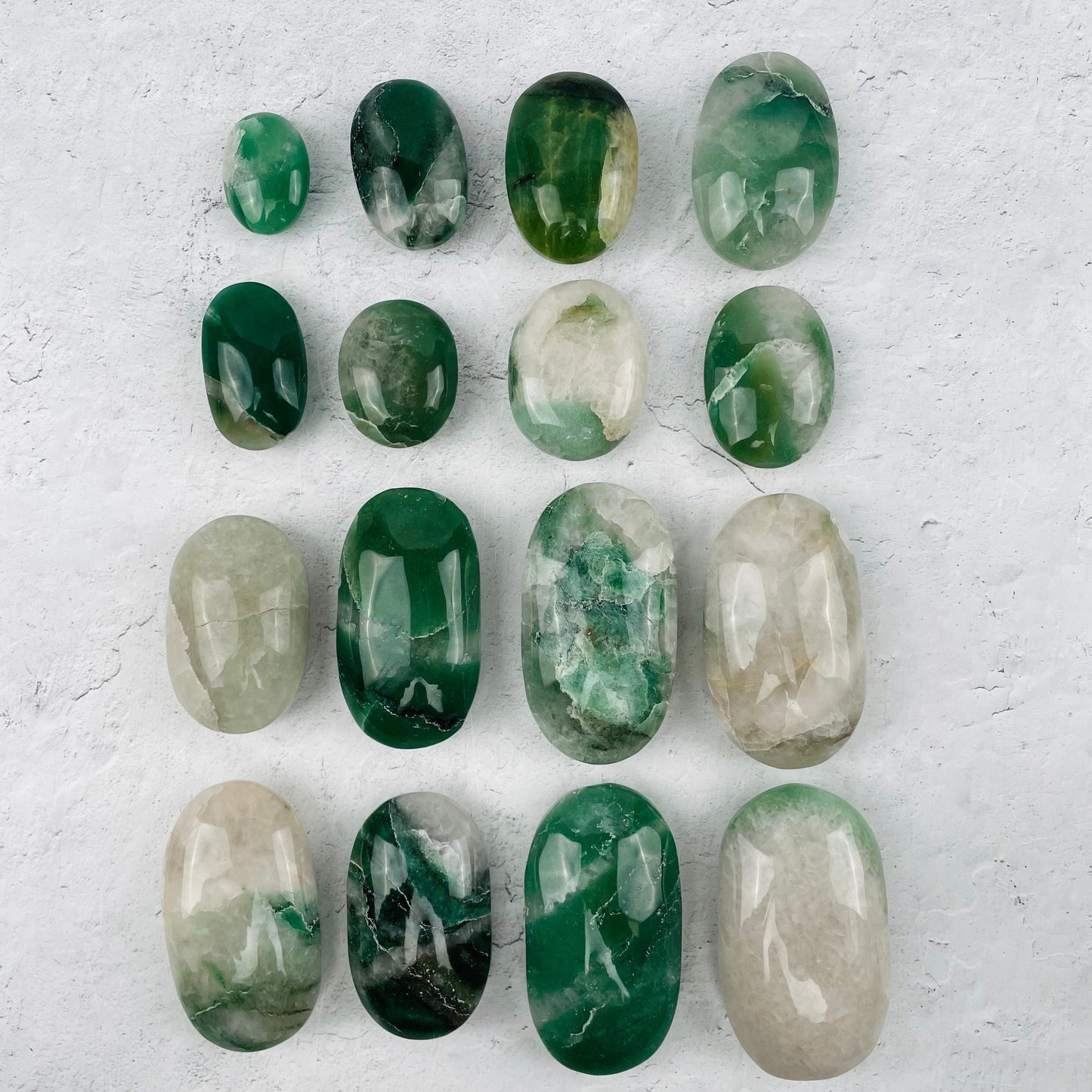 multiple palm stones displayed to show the differences in the color shades and sizes 