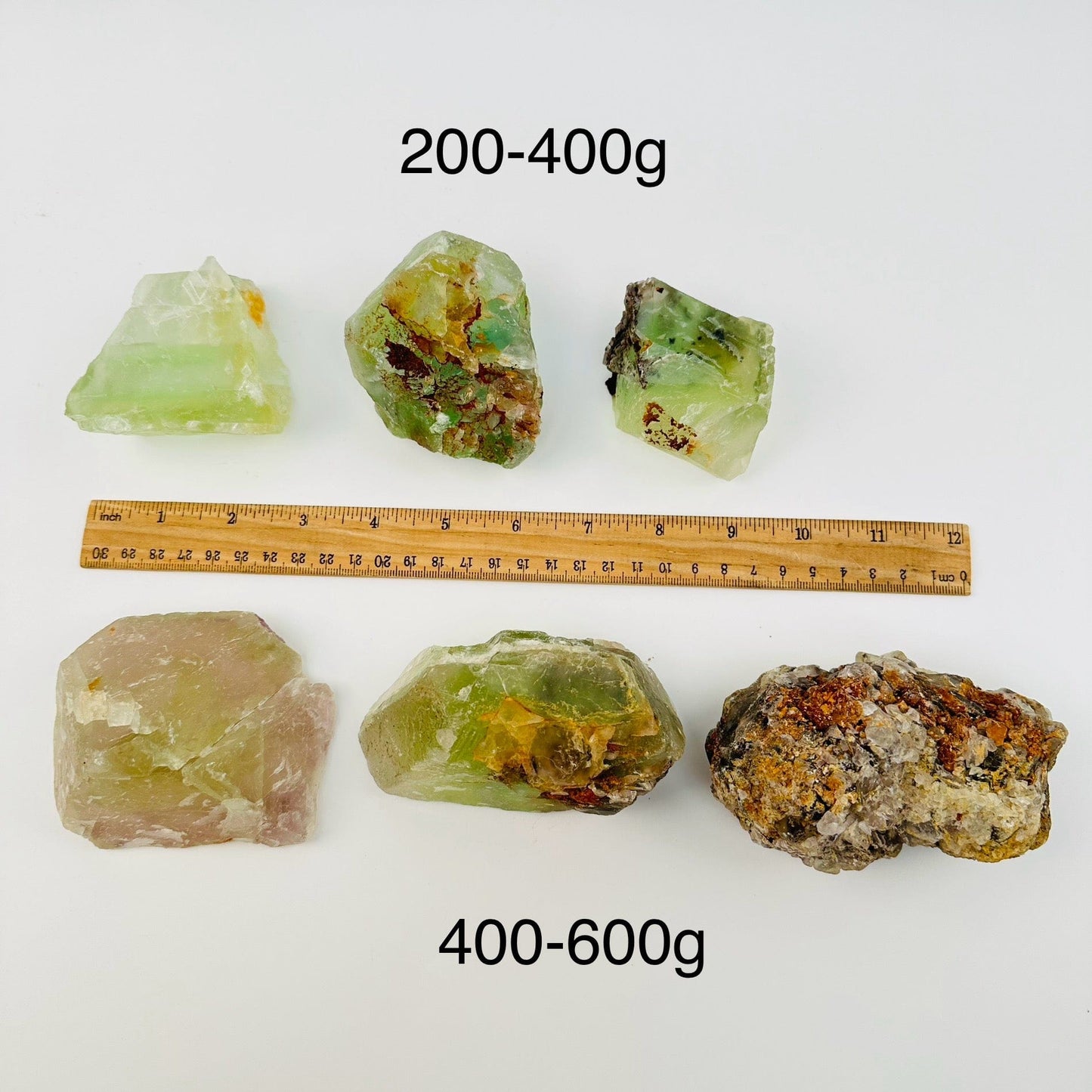 high quality fluorite crystal clusters sold by the weight. displayed next to a ruler for size reference 