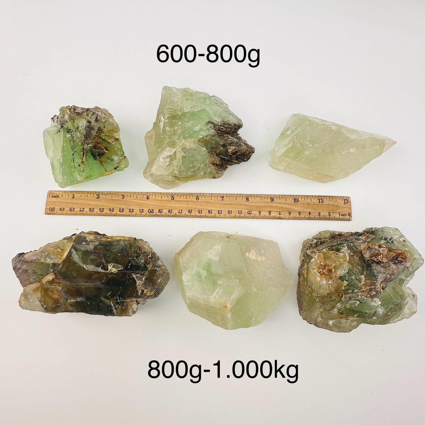 high quality fluorite crystal clusters sold by the weight. displayed next to a ruler for size reference 