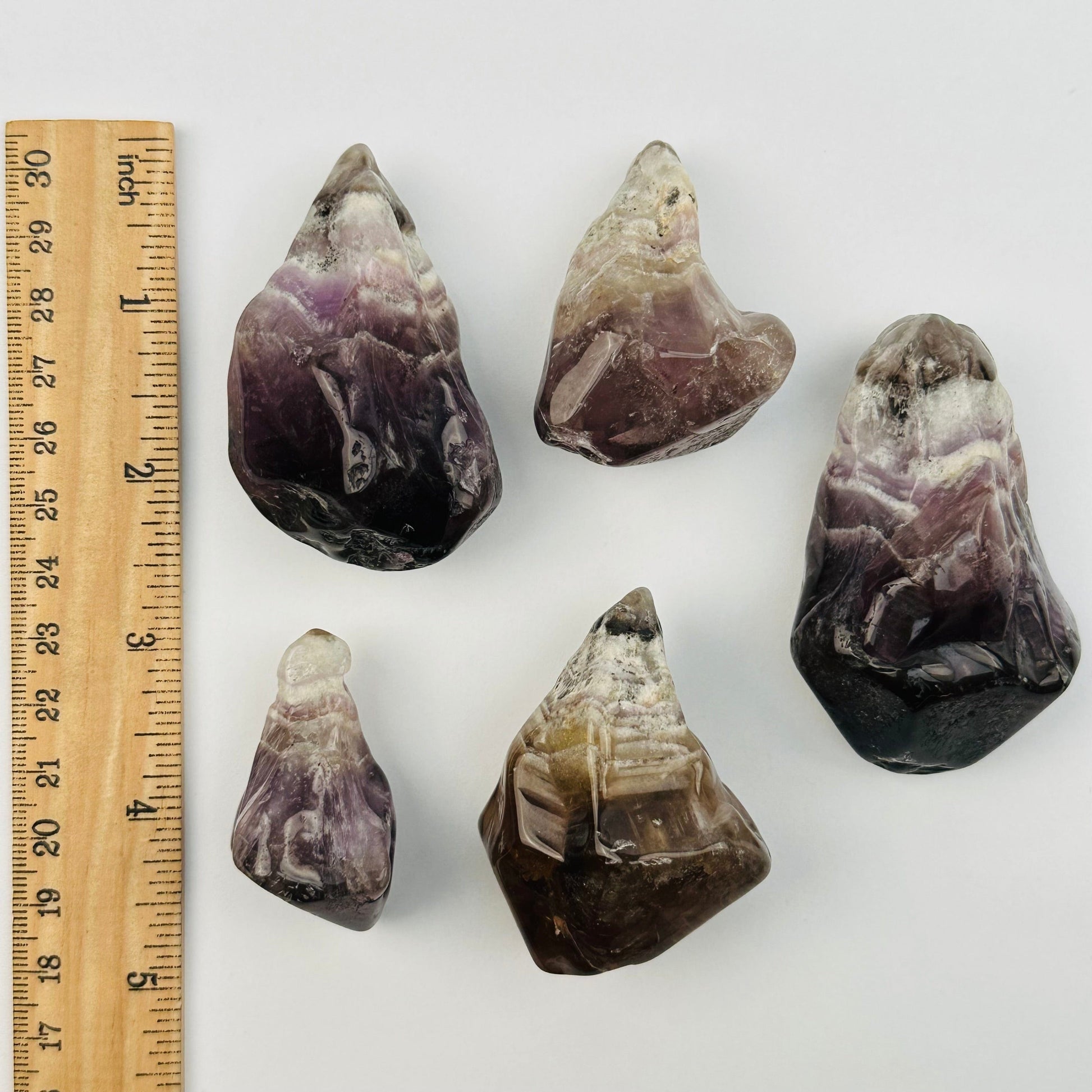 pendants displayed next to a ruler for size reference 