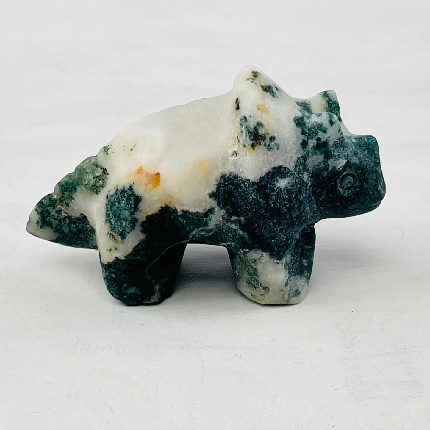 close up of the details on the carved gemstone dinosaur