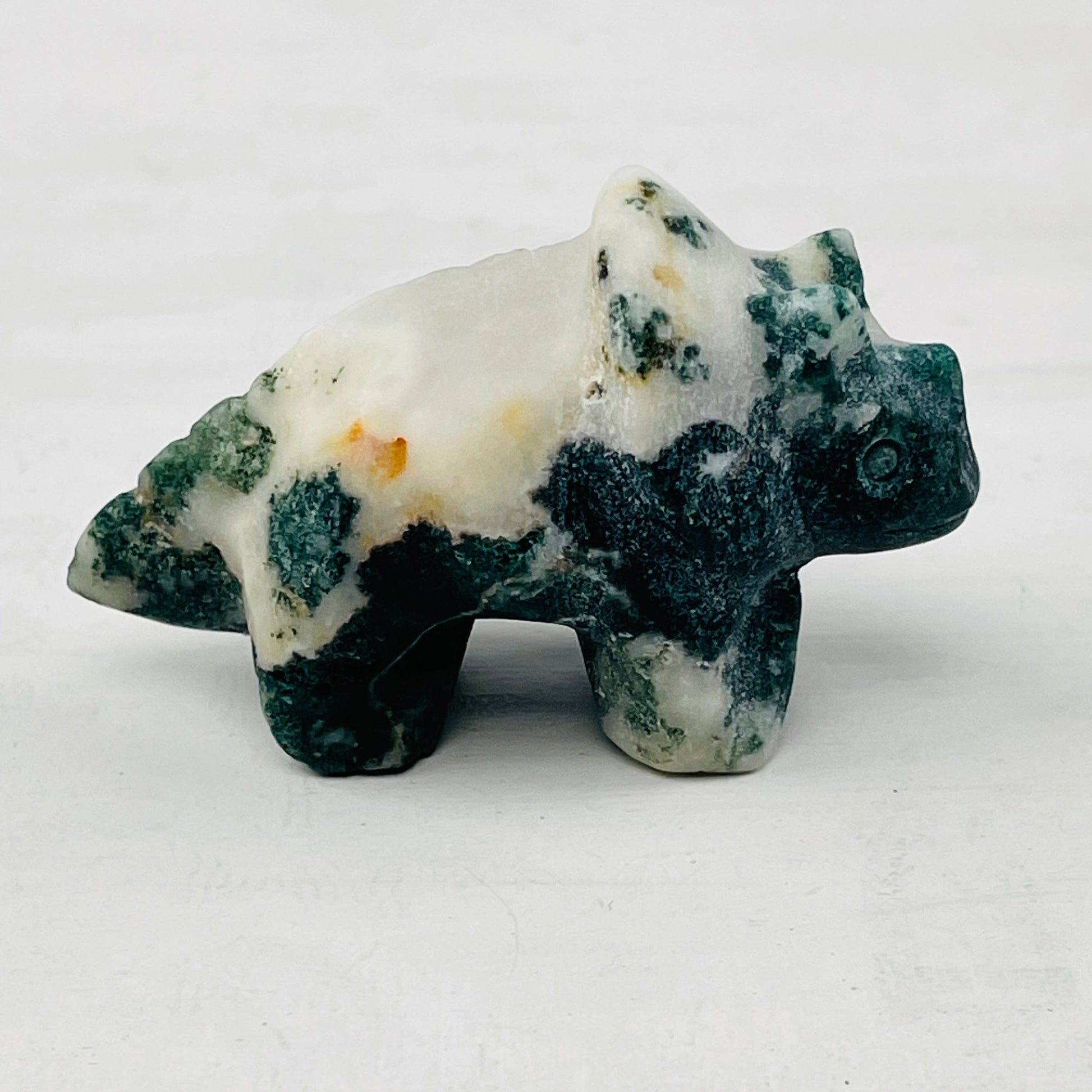 close up of the details on the carved gemstone dinosaur